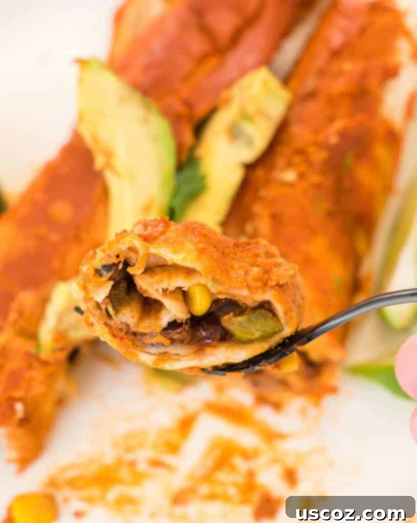 Ultimate Plant-Based Enchiladas 12 fork holding a bite of vegan enchilada