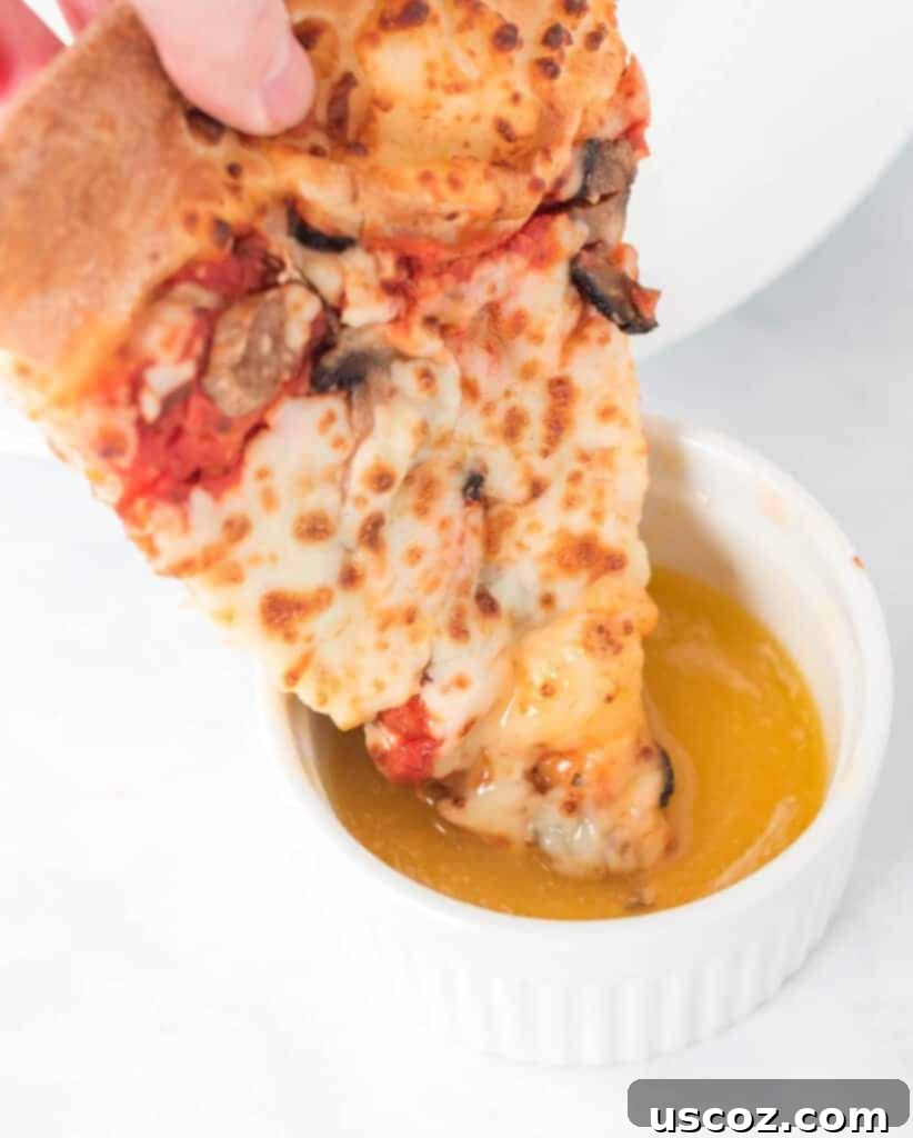 Flavorful Garlic Dip 4 A slice of pizza being dipped into a ramekin of homemade garlic sauce