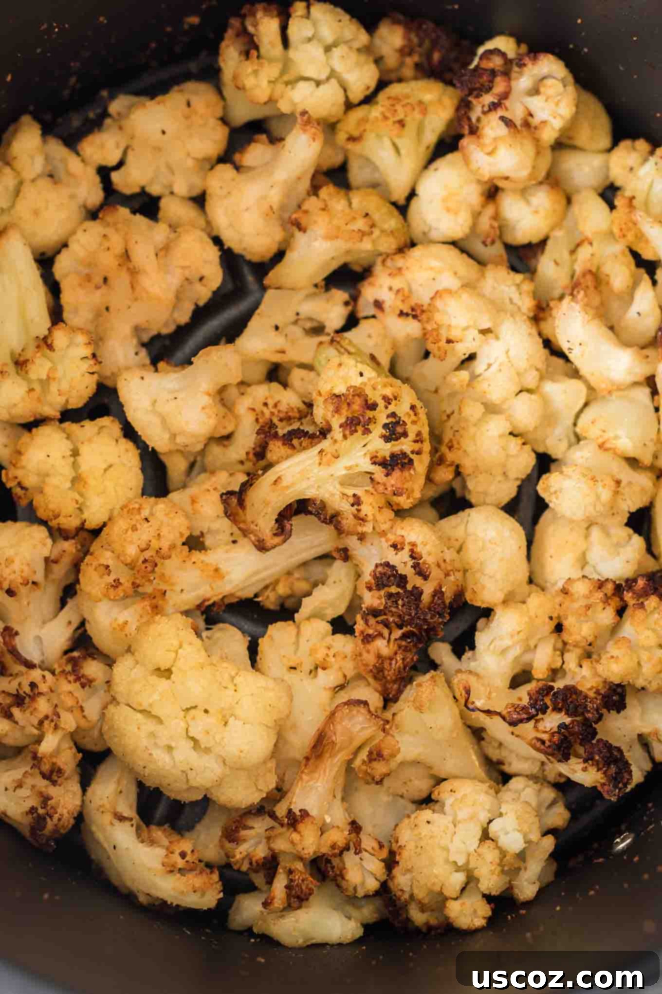 Crispy Air Fryer Frozen Cauliflower 5 A serving of delicious, golden-brown air-fried cauliflower arranged attractively in a rustic white bowl, ready to be enjoyed as a healthy and flavorful side dish.