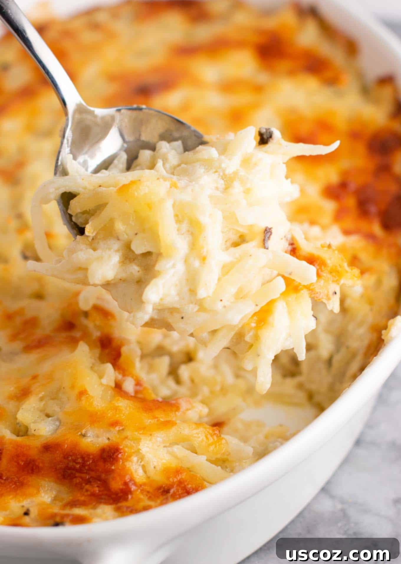 Hearty Hash Brown Bake 3 Scooping a serving of Vegetarian Hash Brown Casserole