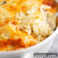 Hearty Hash Brown Bake 8 spoon taking a scoop of hash brown casserole