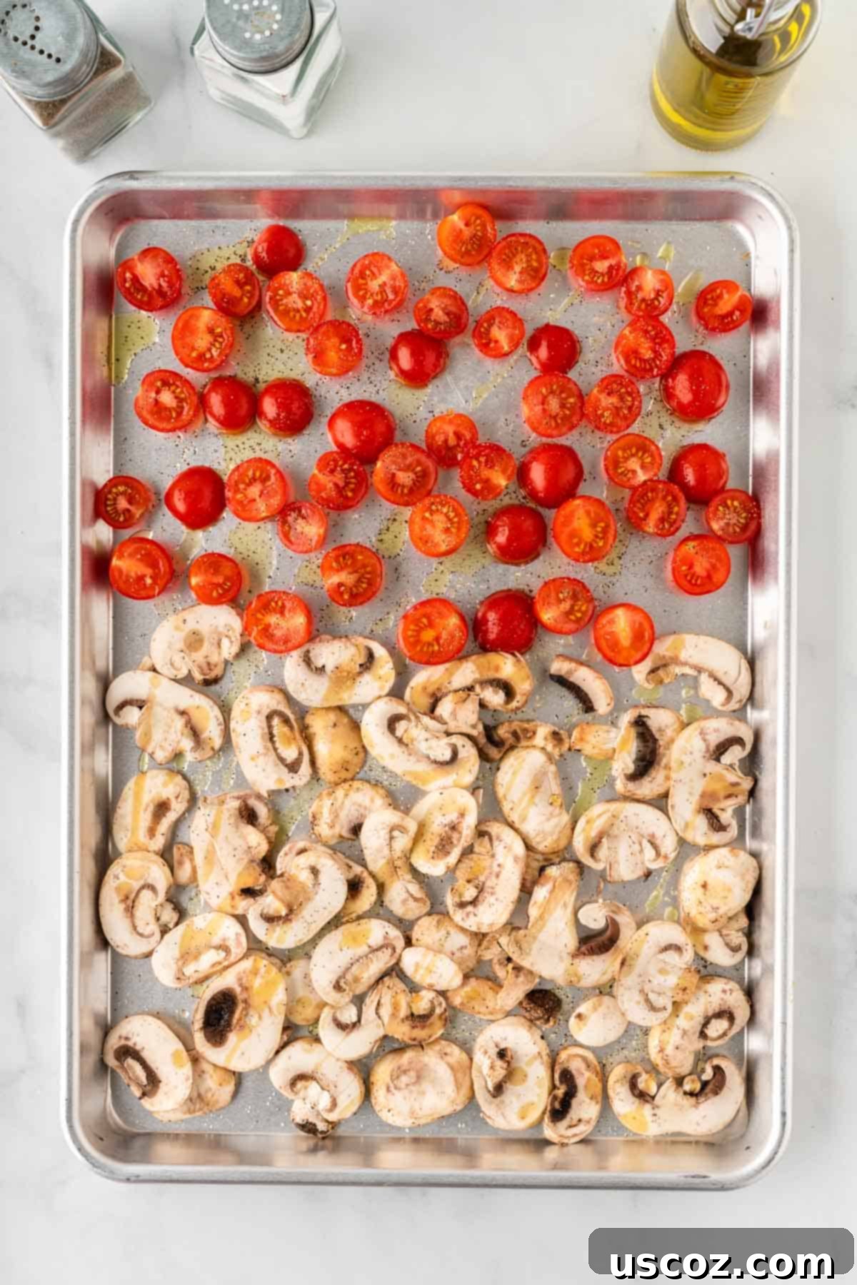 Hearty Roasted Veggie Pasta 7 sliced mushrooms and cherry tomatoes on a baking sheet
