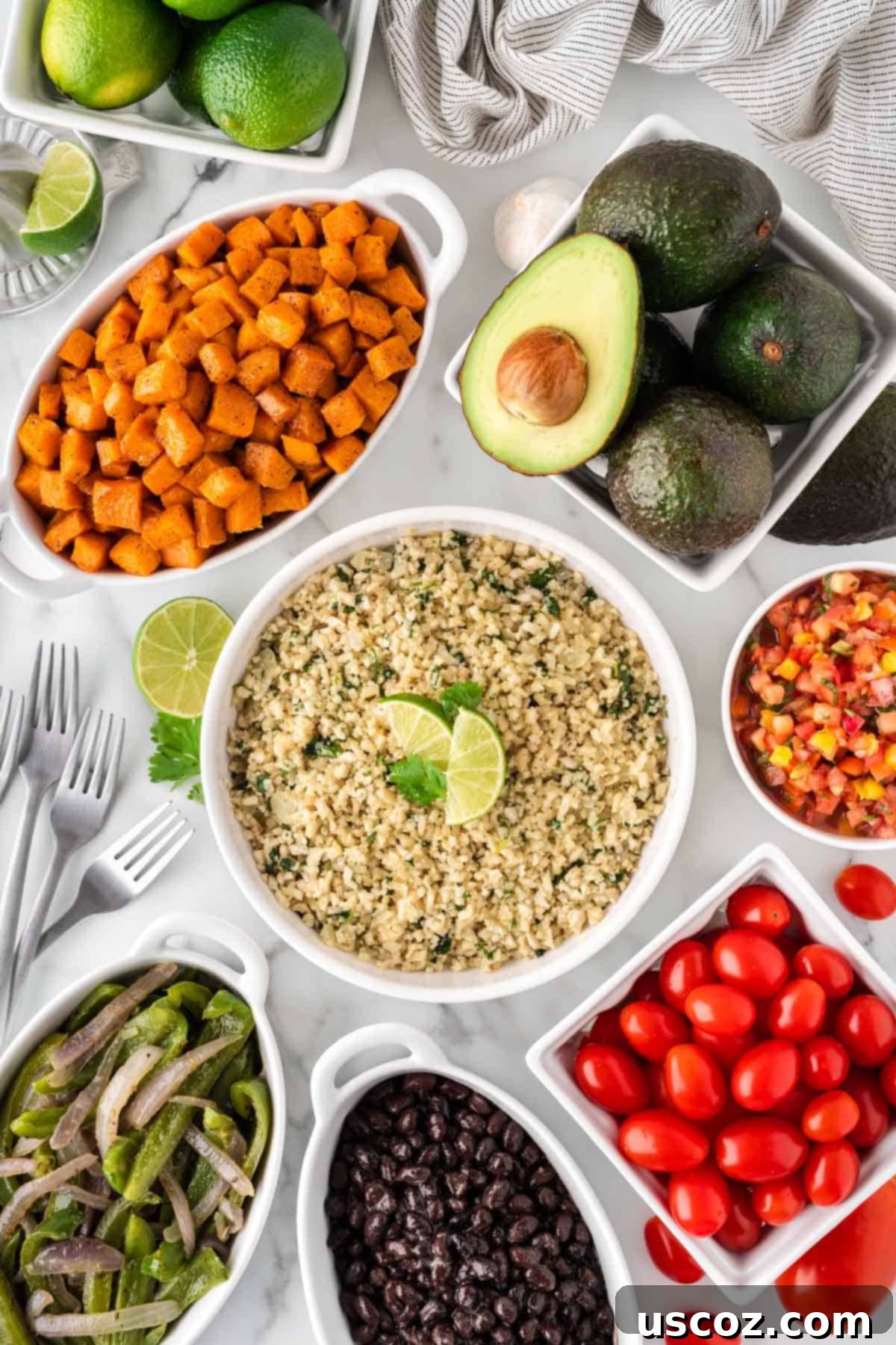 Zesty Cilantro Lime Cauliflower Rice 3 Various components of a cauliflower rice burrito bowl, including cilantro lime cauliflower rice, fajita vegetables, guacamole, and black beans, presented in separate bowls.