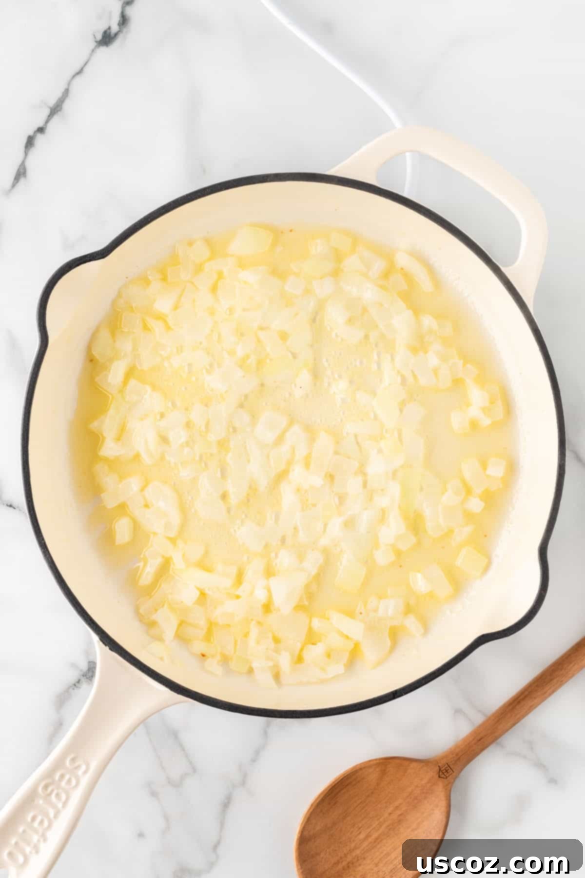 Zesty Cilantro Lime Cauliflower Rice 7 Adding diced yellow onion and minced garlic to the melted butter in a skillet, stirring to soften.