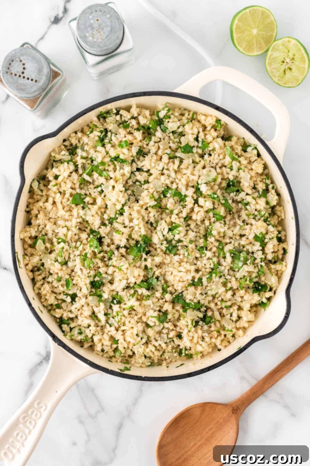 Zesty Cilantro Lime Cauliflower Rice 10 Finished cilantro lime cauliflower rice, vibrant with green cilantro, stirred in a skillet.