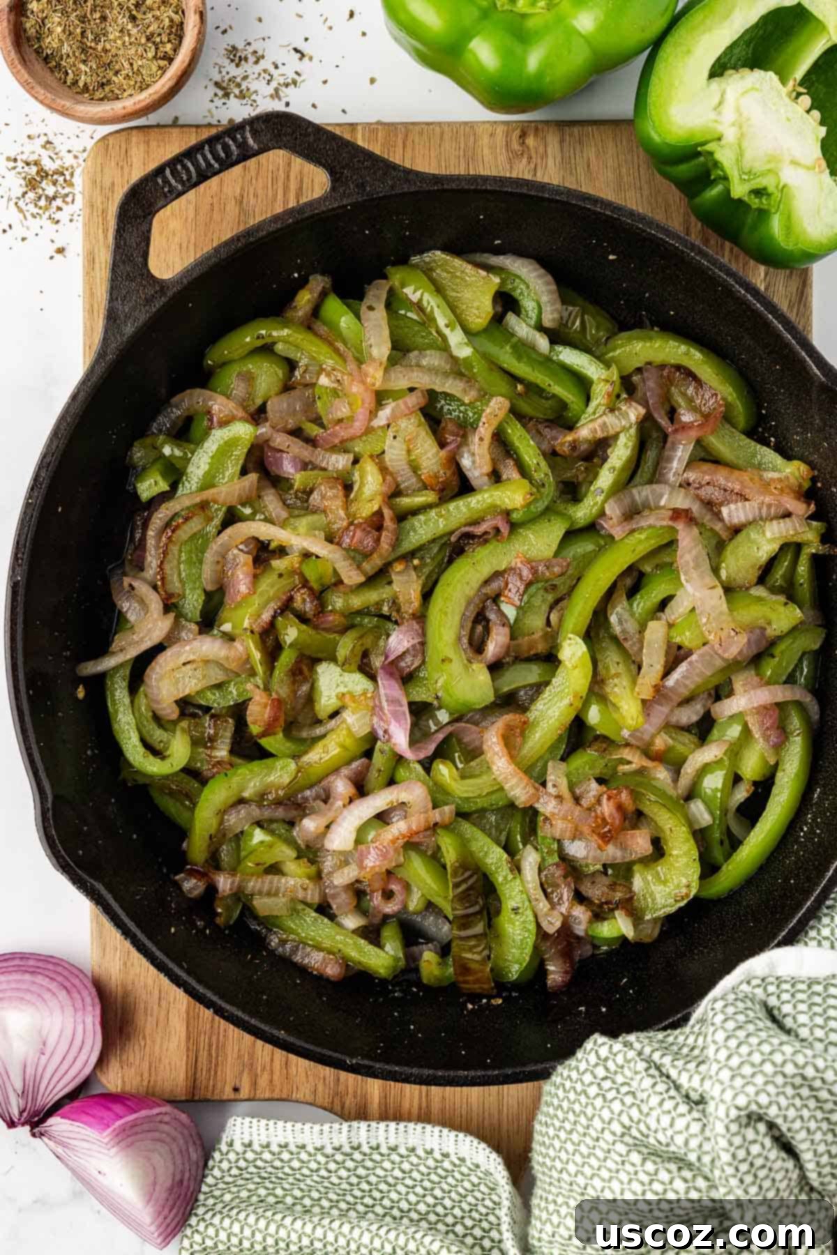 Sizzling Fajita Vegetables 2 Sizzling homemade Chipotle-style fajita veggies in a cast iron skillet, ready to be served.