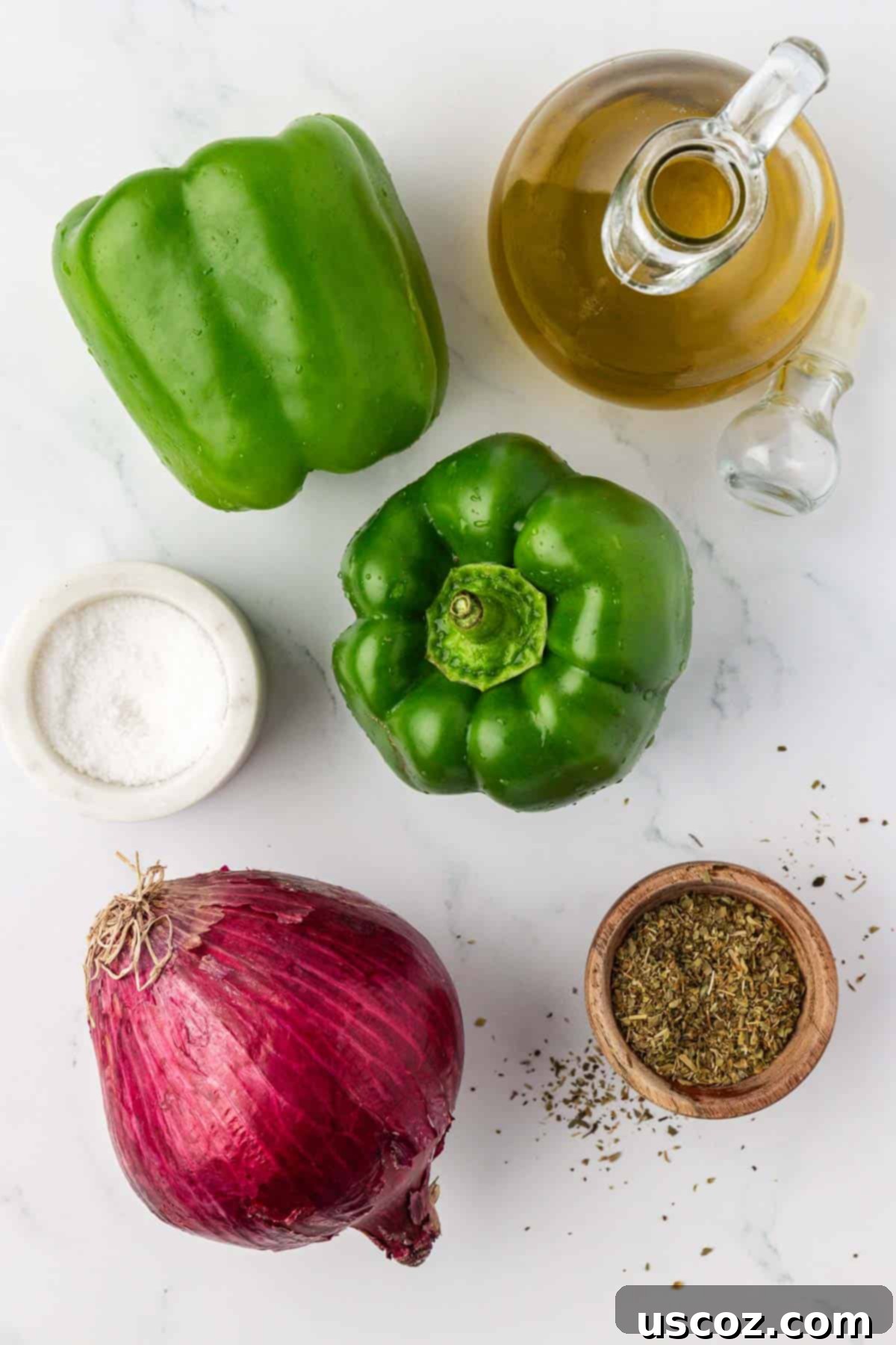 Sizzling Fajita Vegetables 4 Individual ingredients for fajita veggies: vibrant green bell peppers, a halved red onion, a small bowl of salt, dried oregano, and a bottle of olive oil.