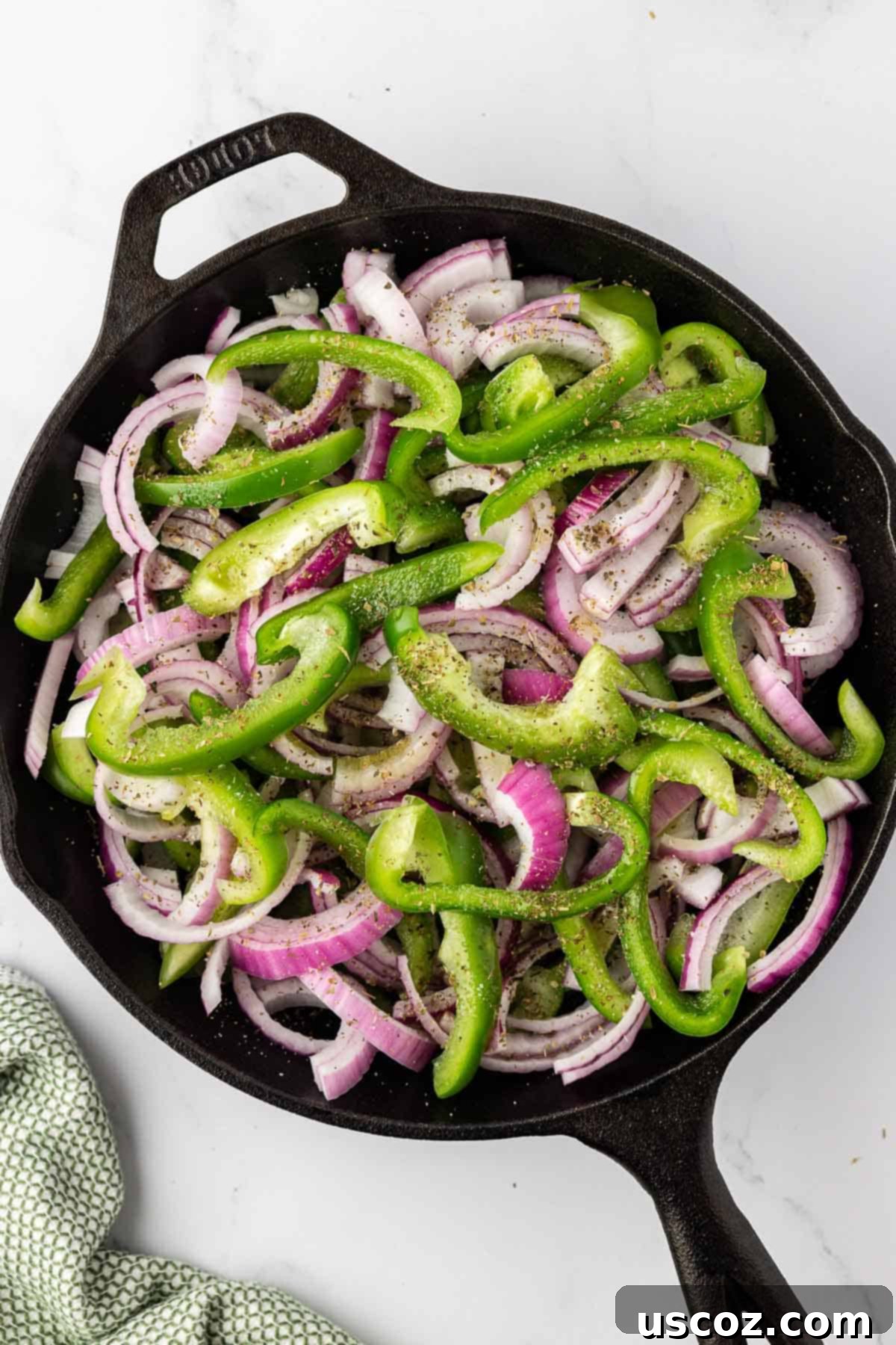 Sizzling Fajita Vegetables 7 Fajita veggies actively sautéing in a hot skillet, with steam rising and edges beginning to soften and caramelize.