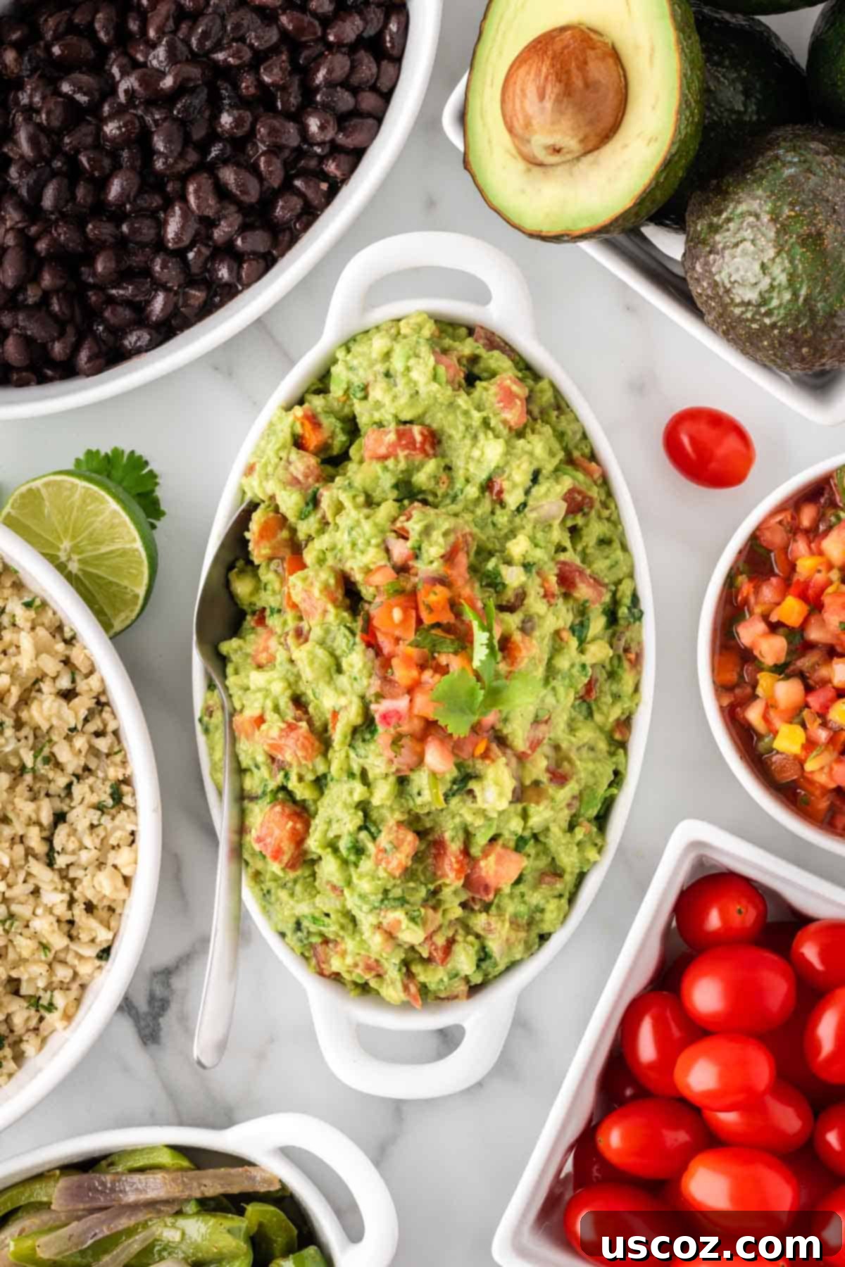 Low-Carb Cauliflower Rice Burrito Bowl 11 Freshly made guacamole in a serving dish, ready to be added to burrito bowls
