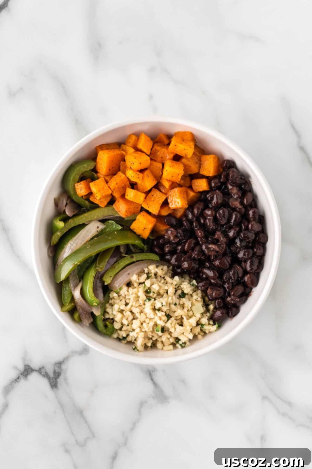 Low-Carb Cauliflower Rice Burrito Bowl 13 Adding roasted sweet potatoes and seasoned black beans to a burrito bowl