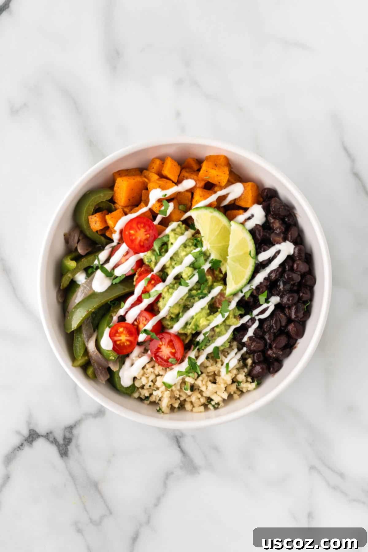 Low-Carb Cauliflower Rice Burrito Bowl 17 Drizzling a creamy sauce, possibly sour cream or vegan crema, over a finished burrito bowl
