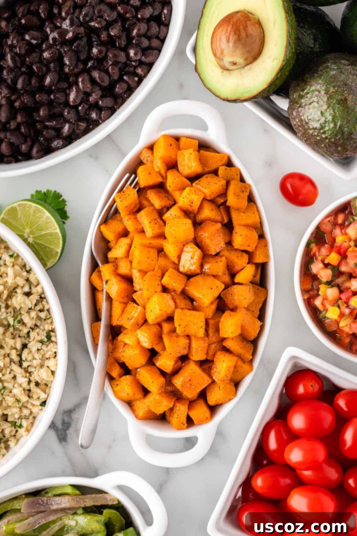 Low-Carb Cauliflower Rice Burrito Bowl 5 Roasted sweet potato cubes served in a bowl, golden brown and tender