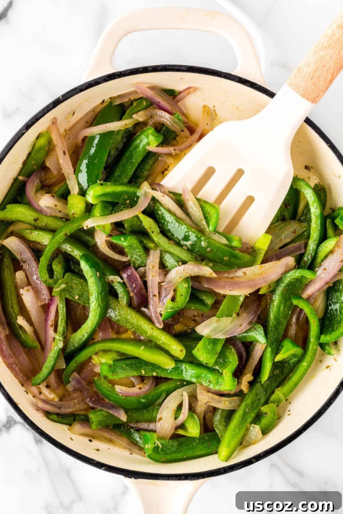 Low-Carb Cauliflower Rice Burrito Bowl 6 Stirring colorful fajita vegetables (bell peppers and onions) in a pan