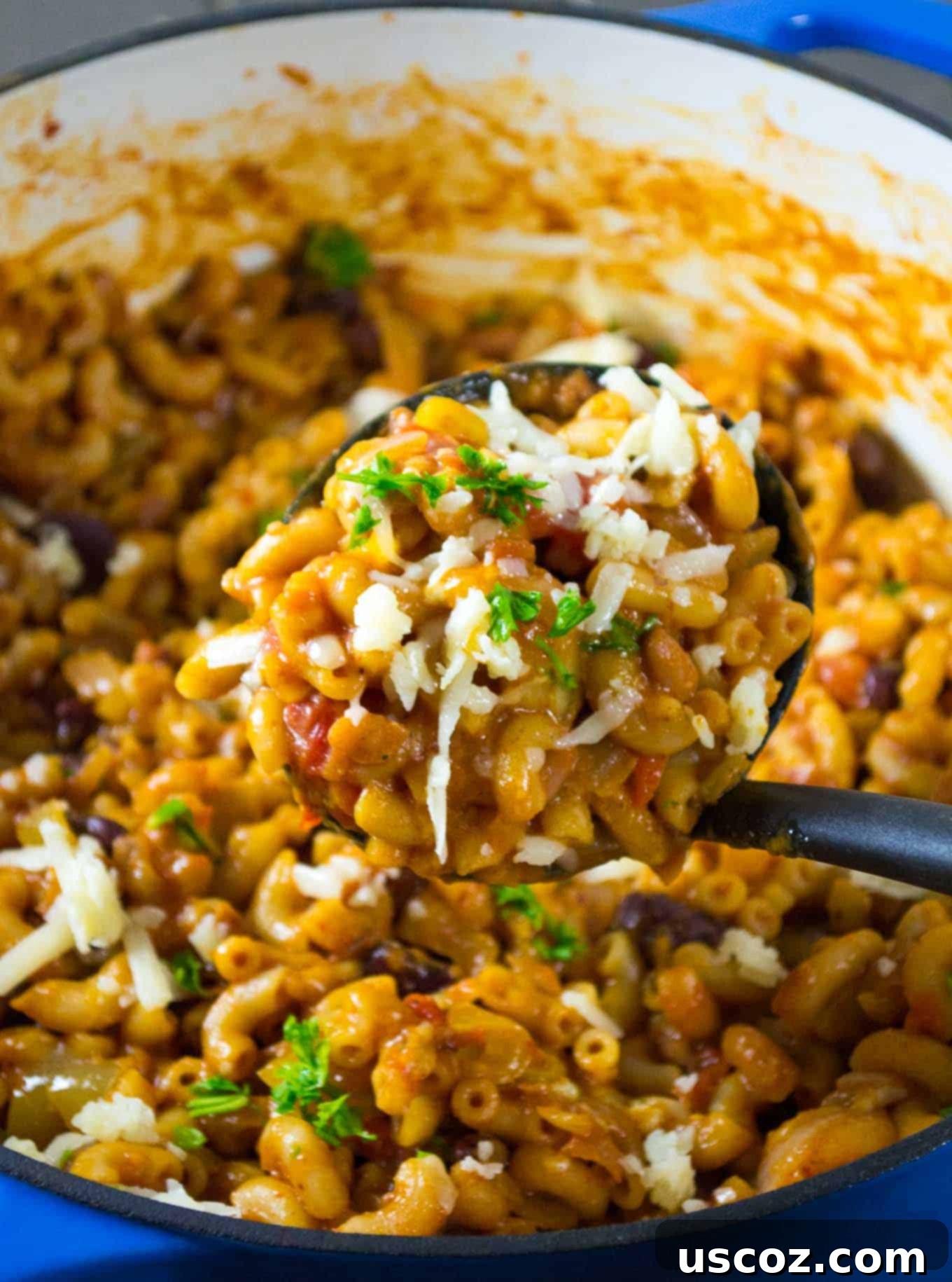 Hearty One-Pan Veggie Chili Mac 9 One Pot Vegetarian Chili Mac with a serving spoon, close up