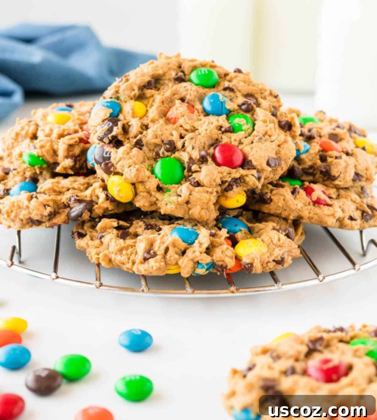 Irresistible Gluten-Free Monster Cookies 2 Stacked gluten-free monster cookies on a cooling rack, showcasing their vibrant M&M's and chocolate chips