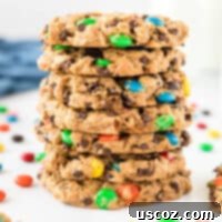 Irresistible Gluten-Free Monster Cookies 14 Gluten-free monster cookies stacked with colorful M&M's visible.