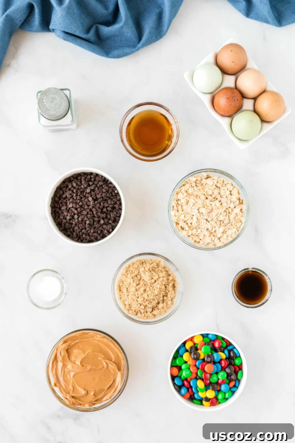 Irresistible Gluten-Free Monster Cookies 4 All the gluten-free monster cookie ingredients, including peanut butter, oats, M&M's, and chocolate chips, neatly lined up