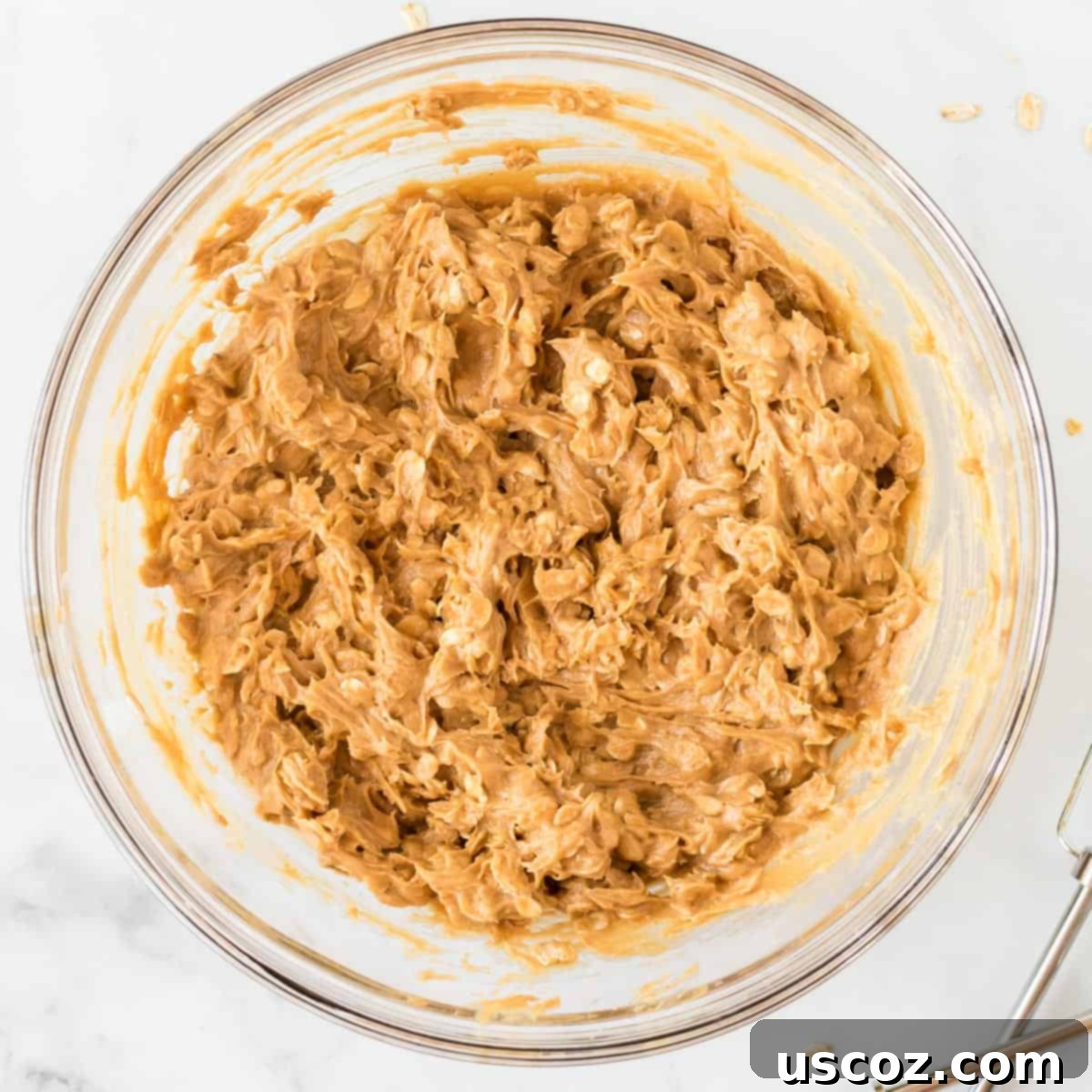 Irresistible Gluten-Free Monster Cookies 8 The cookie dough is perfectly mixed with gluten-free rolled oats, creating a rich and textured batter.