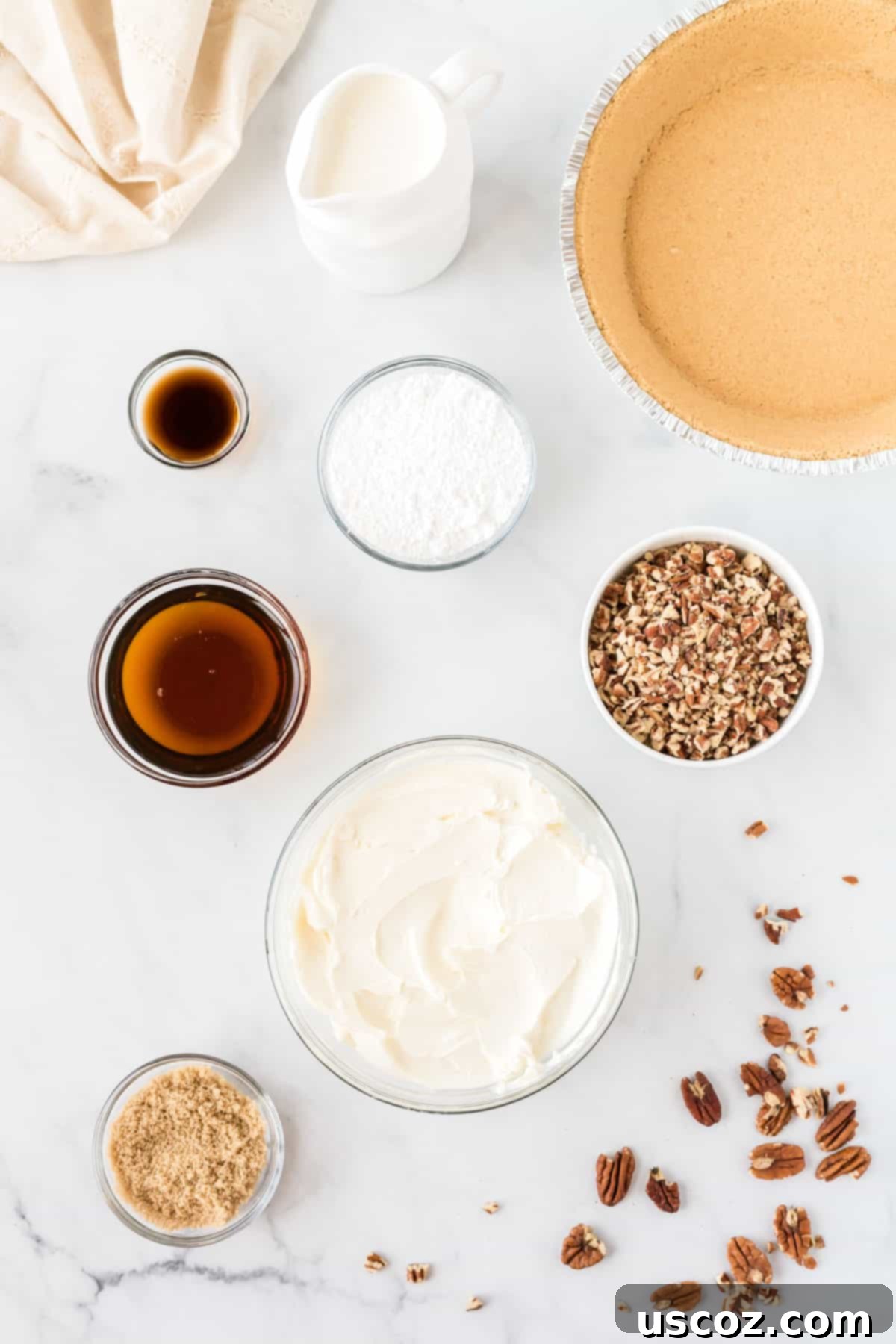Velvet Pecan Delight 3 Overhead view of all the pecan cream pie ingredients laid out on a table, ready for baking.