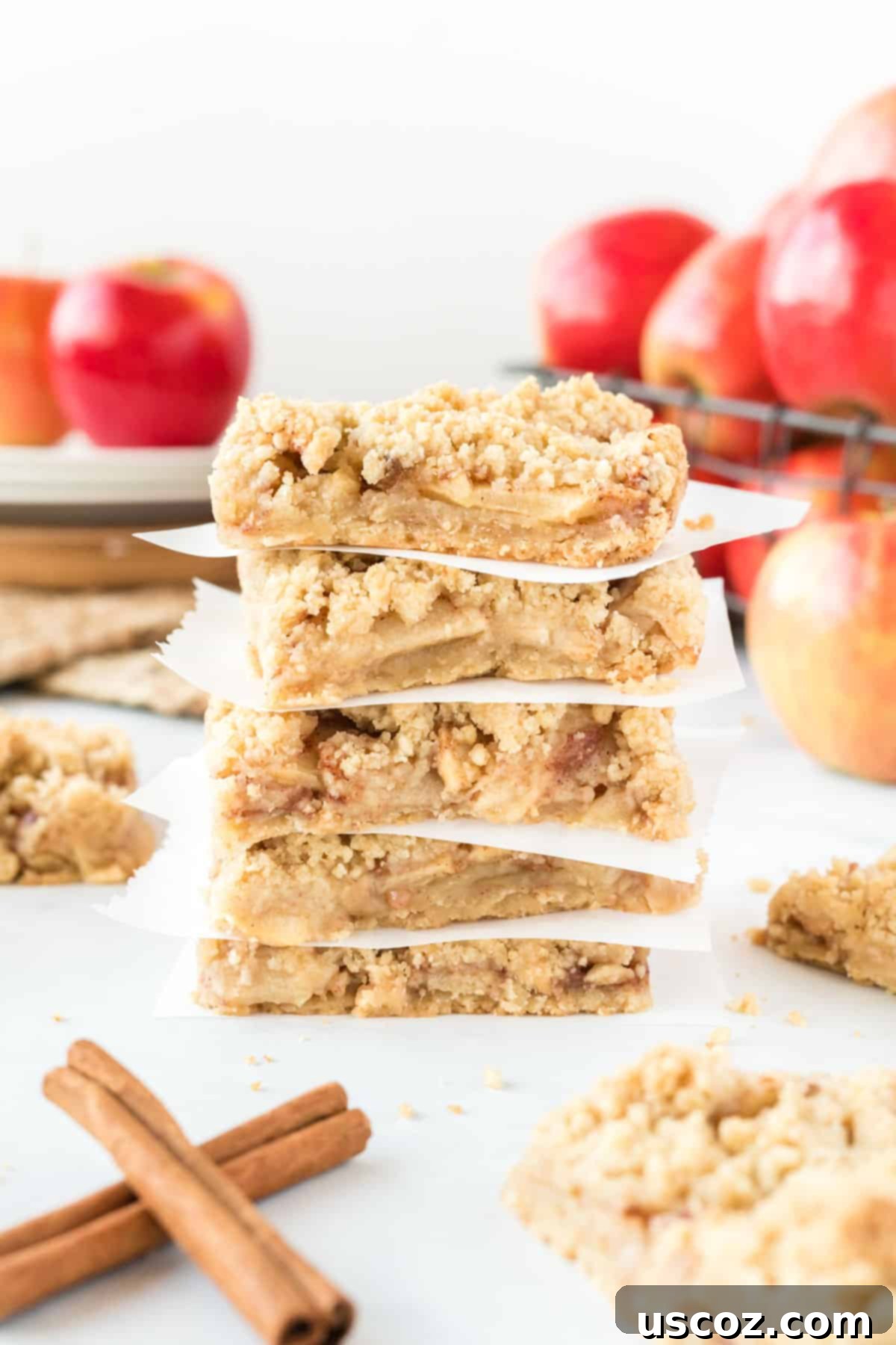 Cinnamon Apple Crumble Bars 13 Perfectly stacked apple crisp bars separated by parchment paper