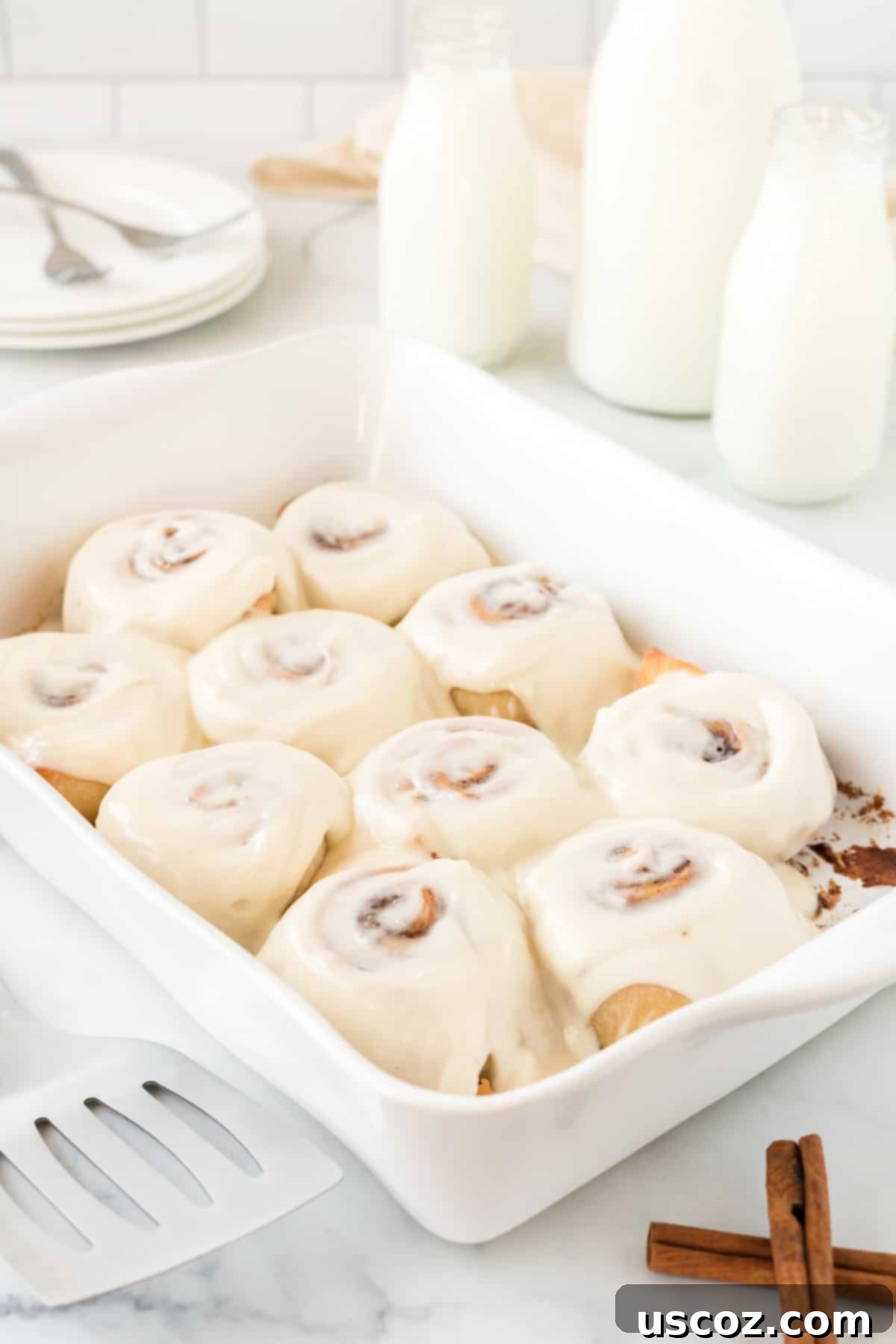 Effortless Cinnamon Swirls 2 frosted cinnamon rolls with cream cheese icing, ready to be served