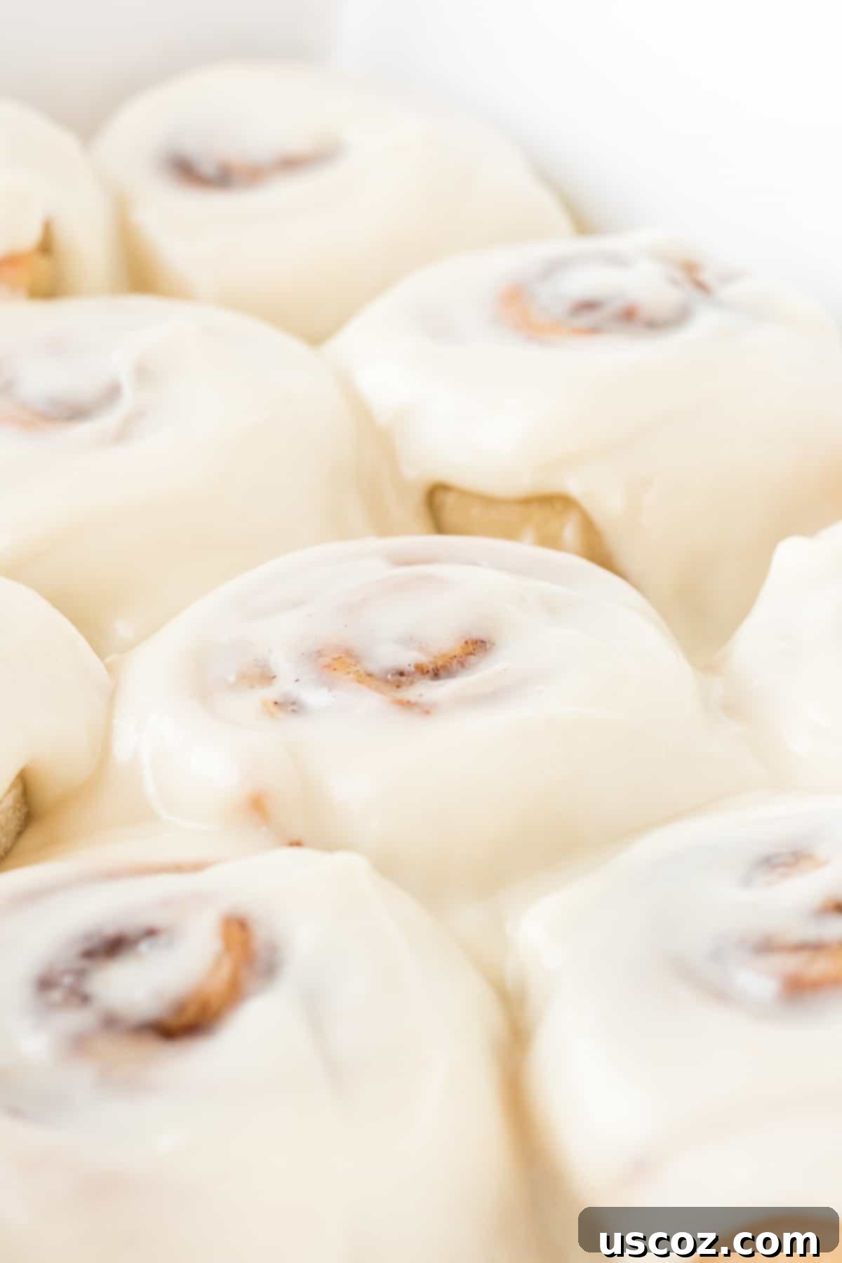 Effortless Cinnamon Swirls 3 frosted cinnamon rolls with rich cream cheese icing in a baking dish