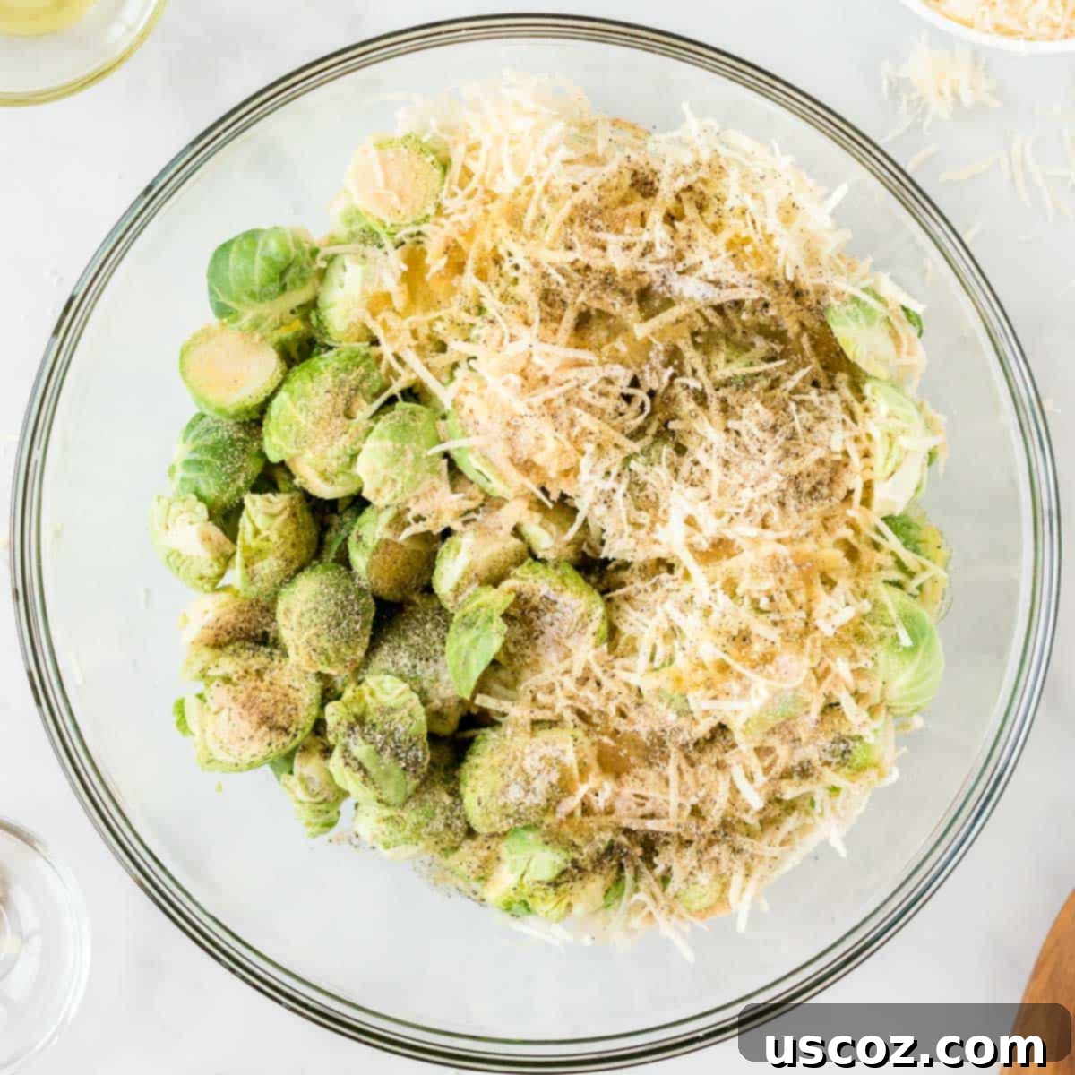 Parmesan Roasted Brussels Sprouts 6 adding the cheese and spices to the brussels sprouts in a bowl