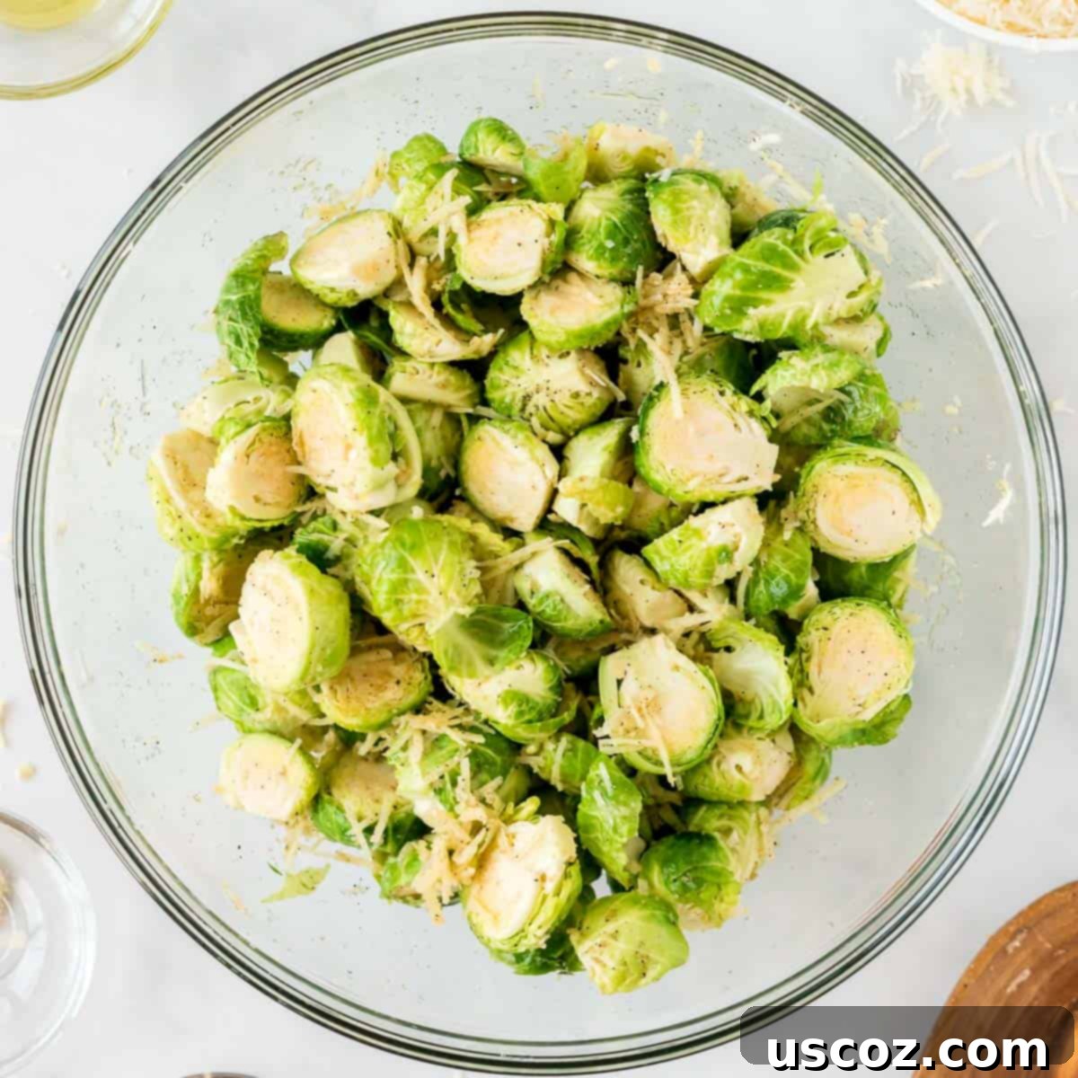 Parmesan Roasted Brussels Sprouts 7 brussels sprouts mixed together with cheese and spices in a bowl
