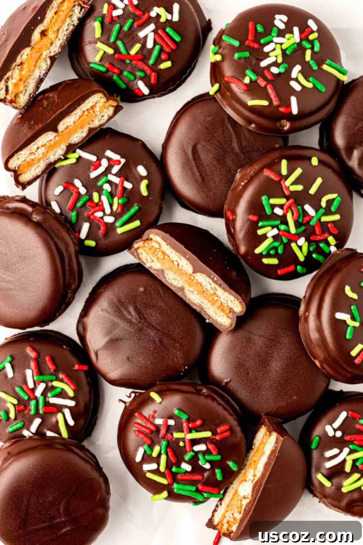 Irresistible Ritz Cookie Bites 2 Ritz Cracker Cookies stacked on a plate, showing the chocolate coating and sprinkles.