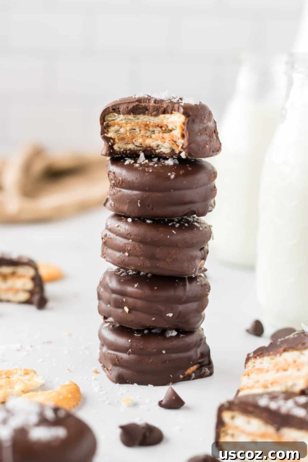 Irresistible Ritz Cookie Bites 3 Stacked Ritz Cracker Cookies, with one on top having a bite taken out, showing the peanut butter filling.