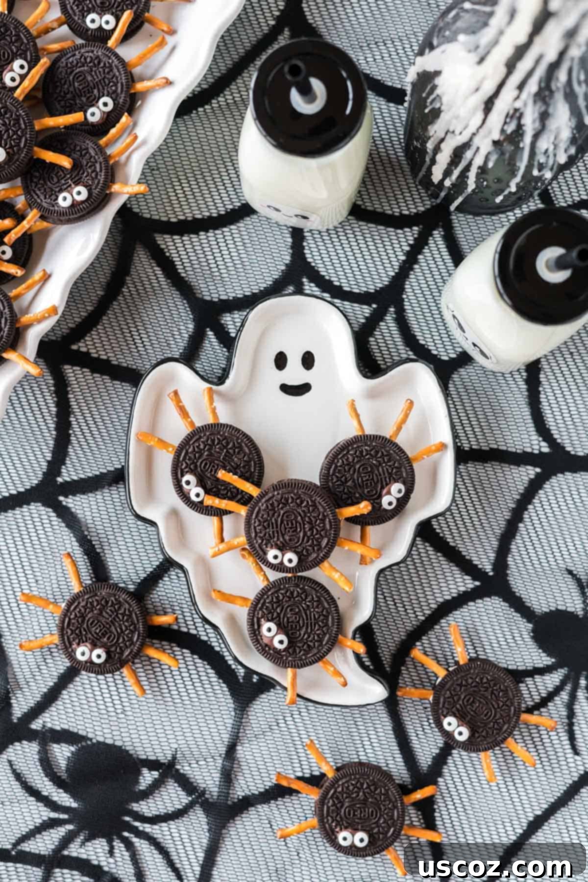 Eight-Legged Oreo Delights 3 Several festive Oreo spiders arranged on a ghost-shaped serving plate, perfect for a Halloween party dessert table.