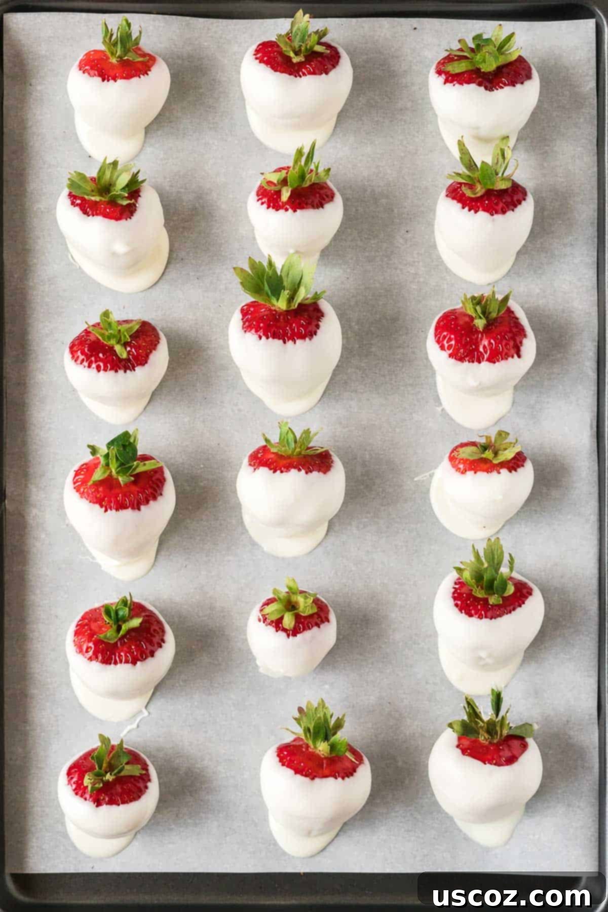 Strawberry Whispers 8 dipped white chocolate strawberries on a baking sheet