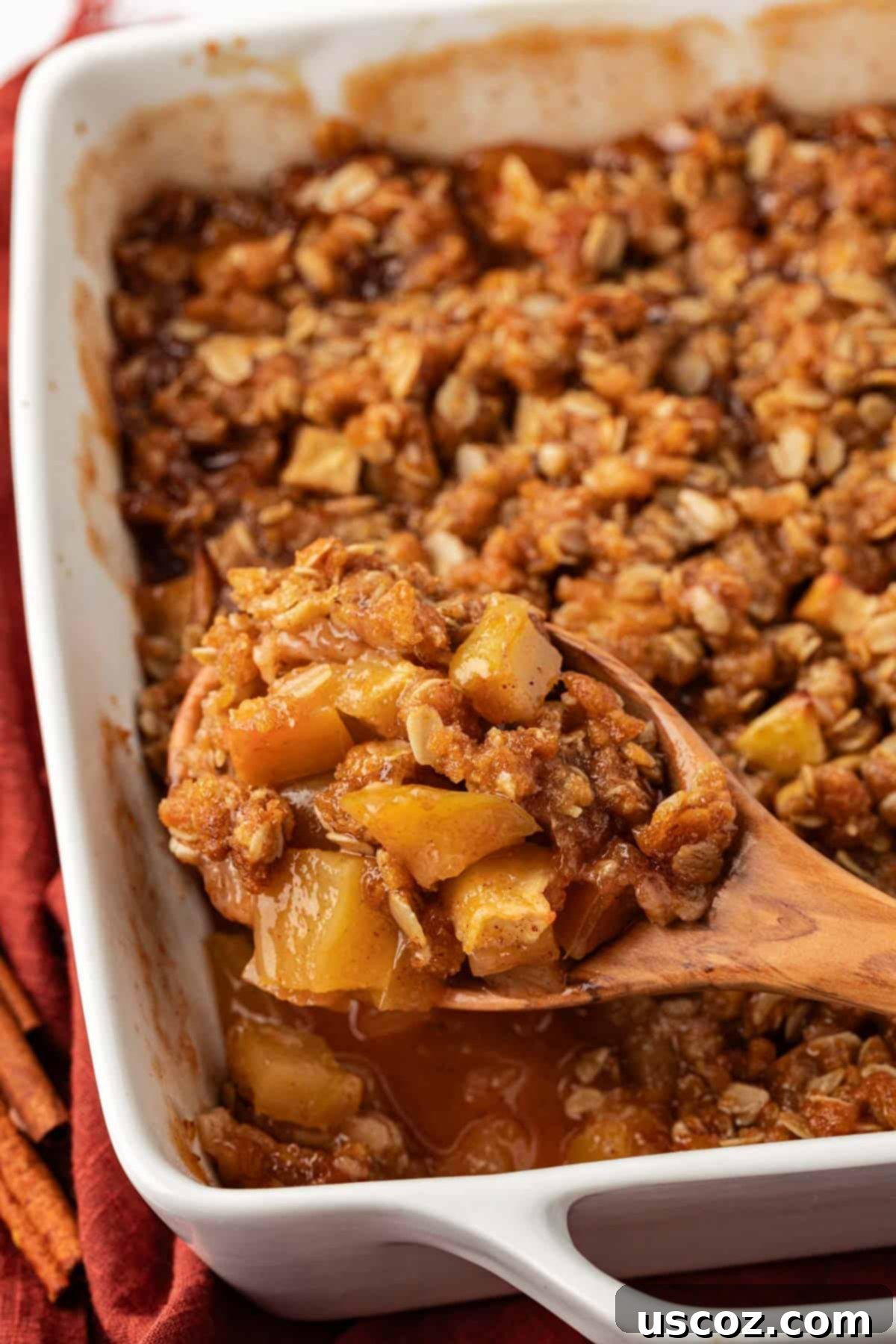 Comforting Vegan Apple Crisp 18 wooden spoon scooping vegan apple crisp