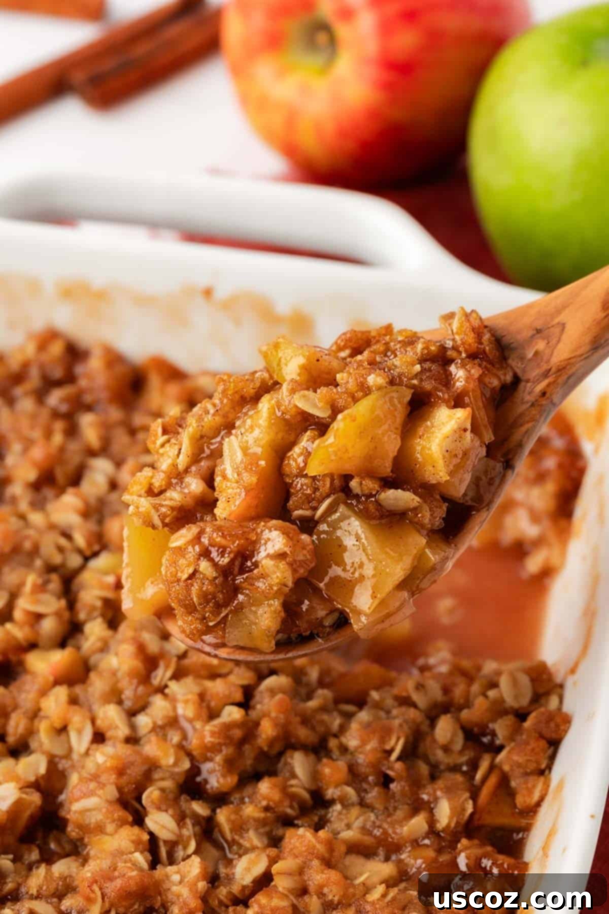 Comforting Vegan Apple Crisp 3 wooden spoon scooping vegan apple crisp