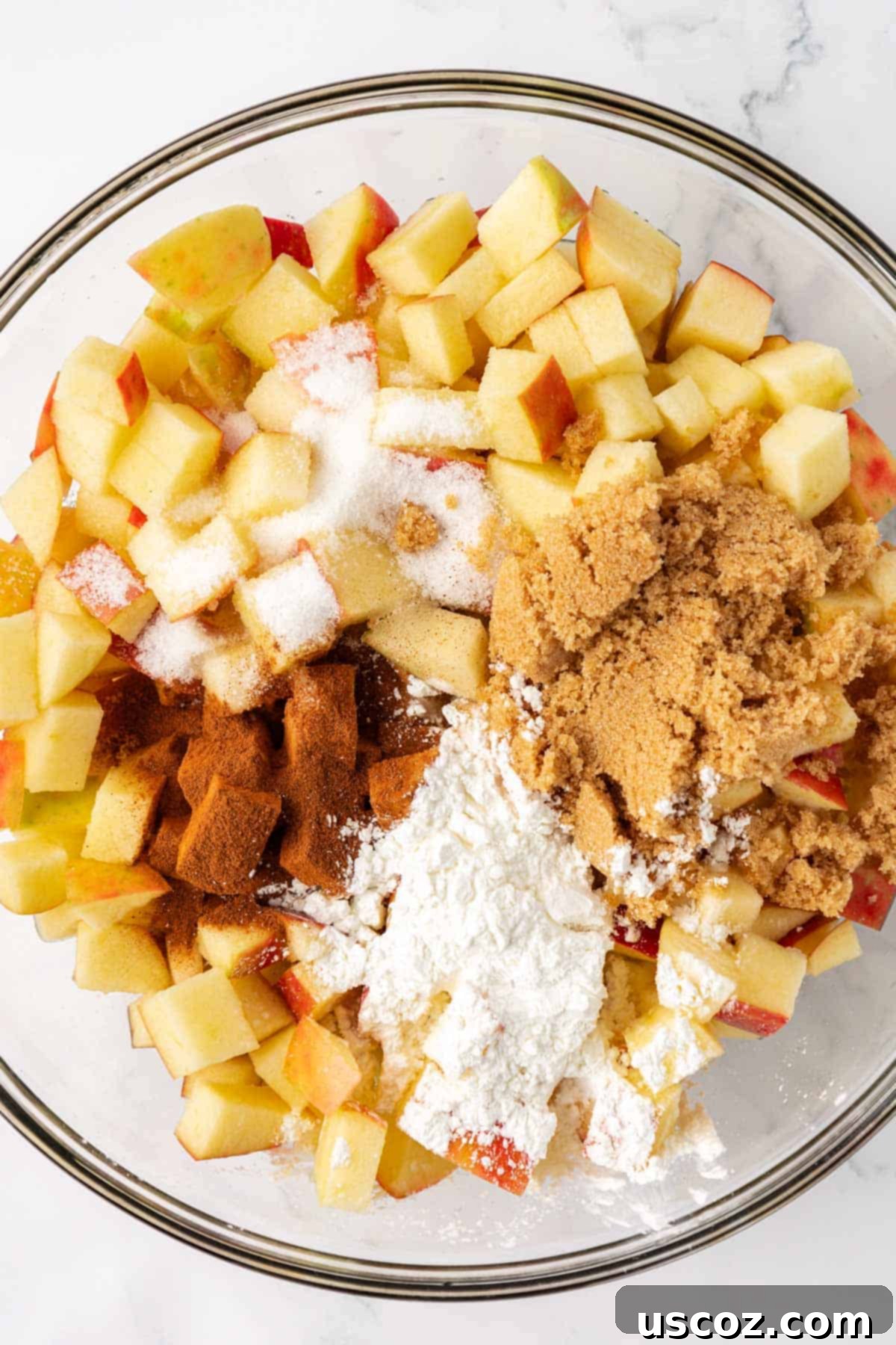 Comforting Vegan Apple Crisp 6 adding the spices to the apples