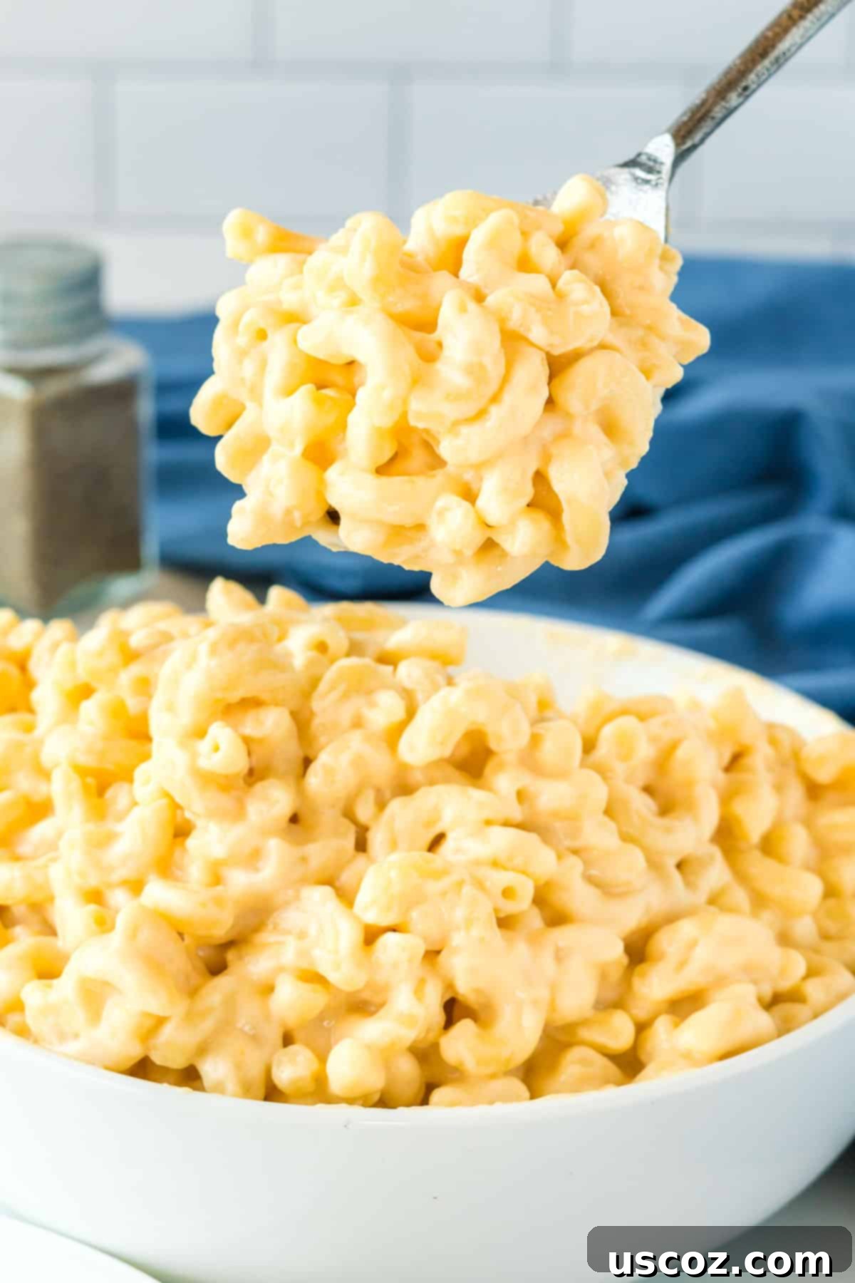 Creamy Greek Yogurt Mac and Cheese 9 serving spoon scooping creamy greek yogurt mac and cheese