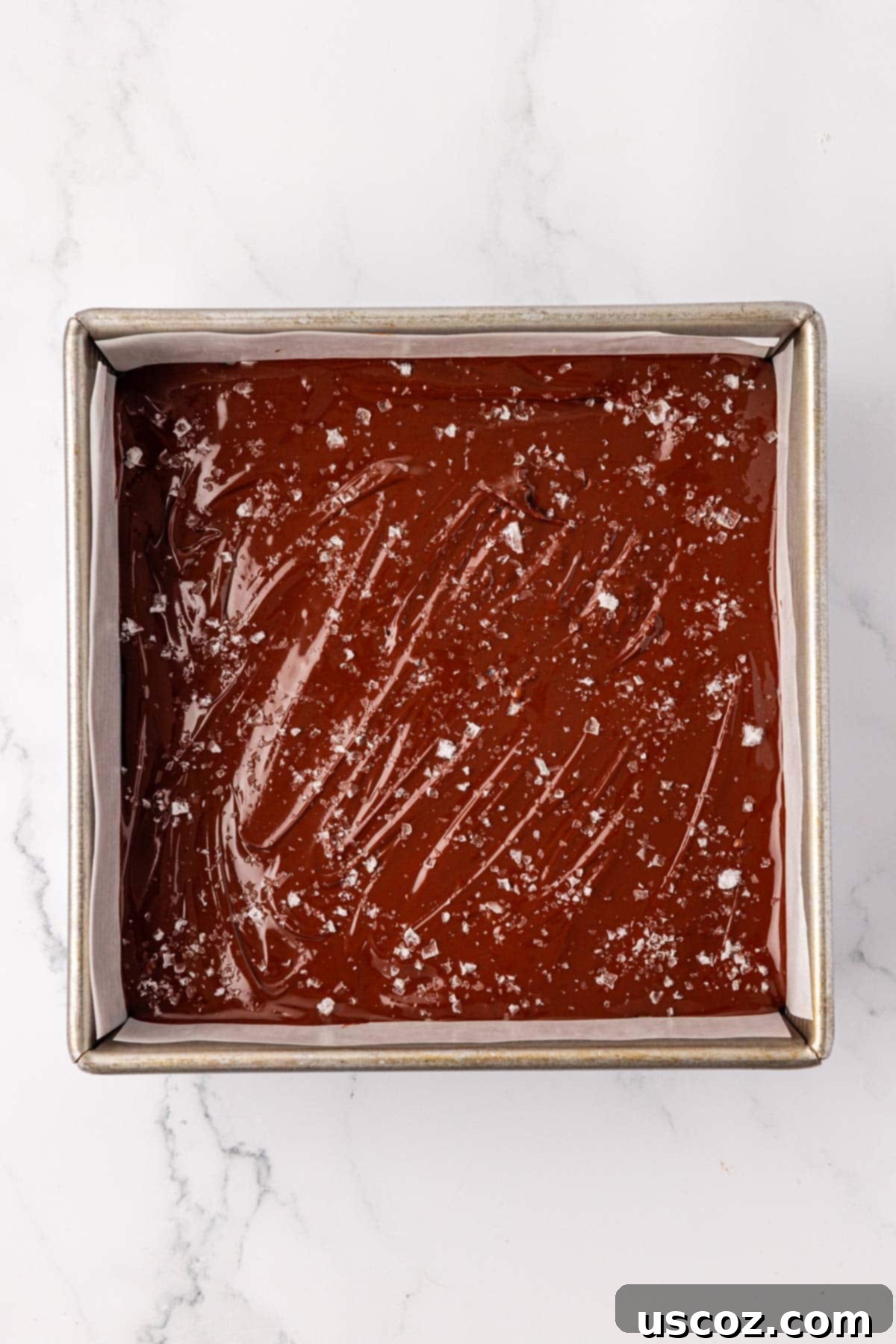 Effortless Protein Bars 16 adding the sea salt flakes on top of the melted chocolate
