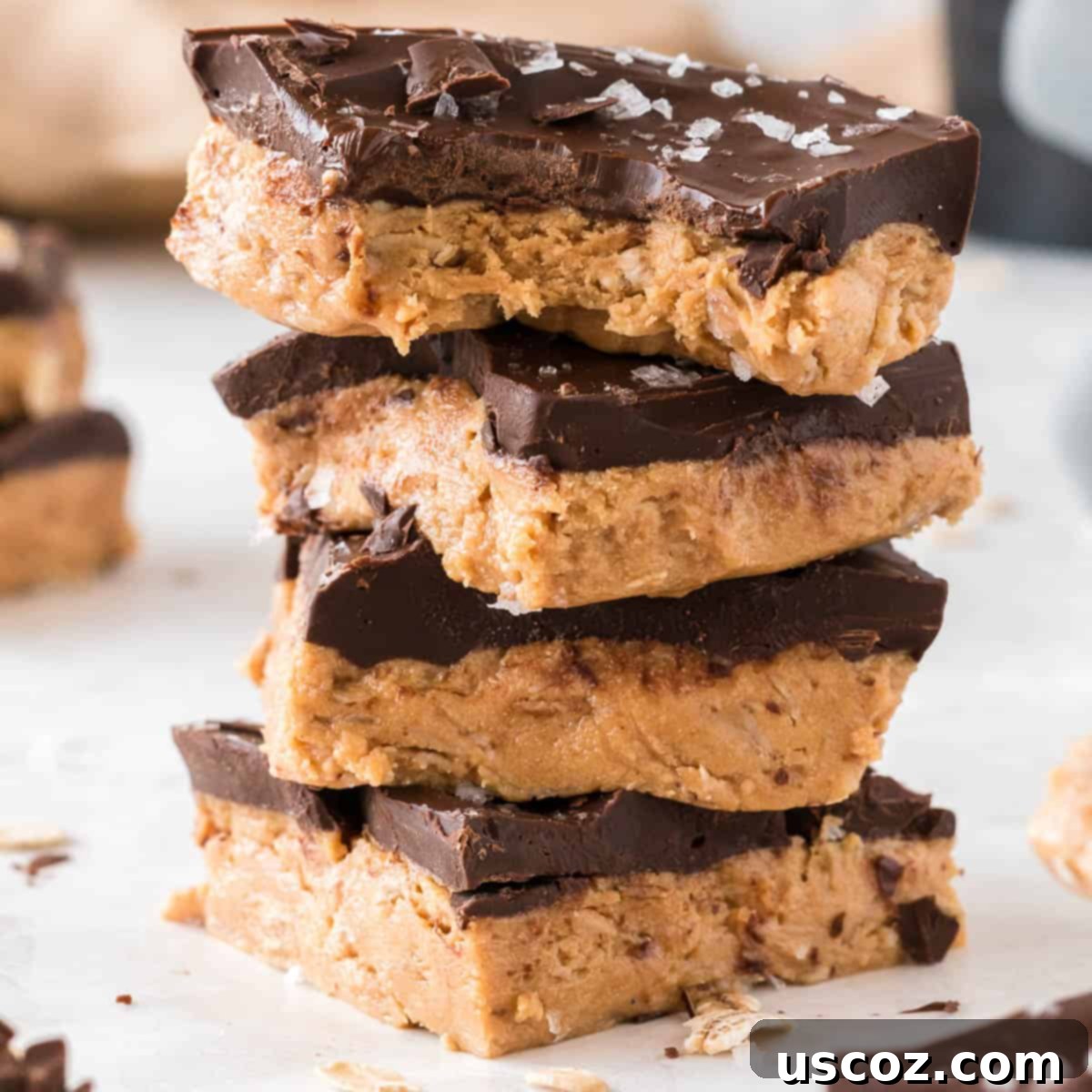 Effortless Protein Bars 22 stacked protein bars with the top one missing a bite