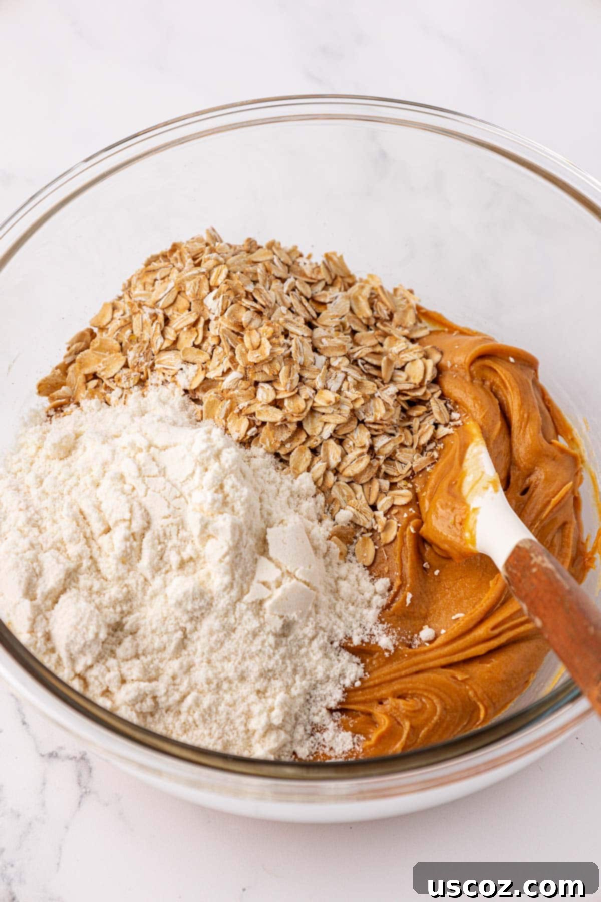 Effortless Protein Bars 7 adding the rest of the protein bar ingredients to the mixing bowl