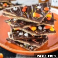 Spooky Halloween Crack 17 Halloween crack candy pieces stacked on an orange plate, an irresistible treat for spooky season.