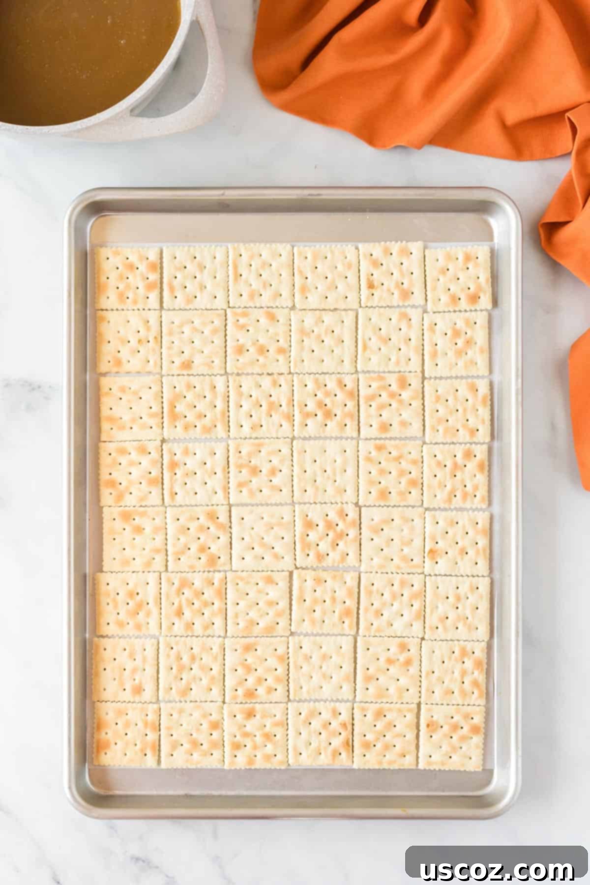 Spooky Halloween Crack 6 Baking sheet lined with saltine crackers, ready for the toffee mixture.