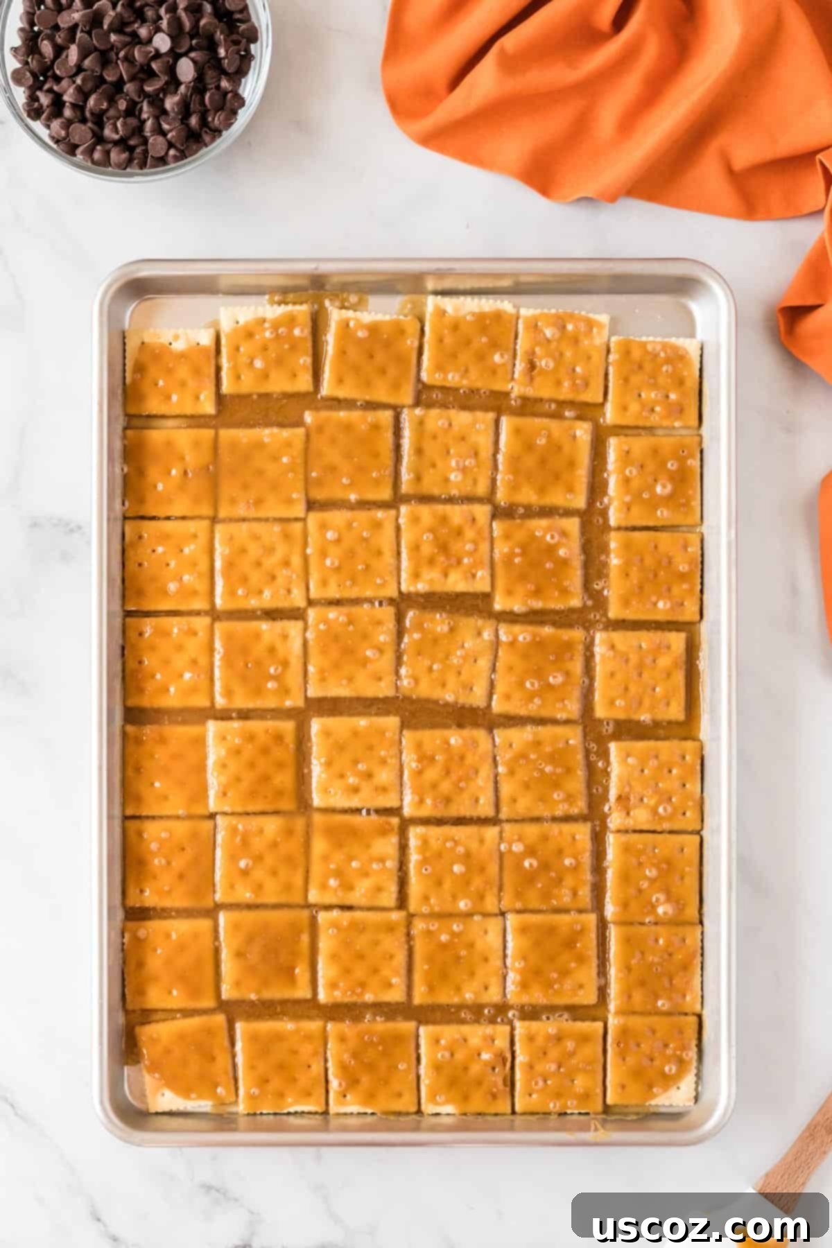 Spooky Halloween Crack 7 Baking sheet with saltine crackers evenly covered in golden-brown toffee, fresh from the oven.