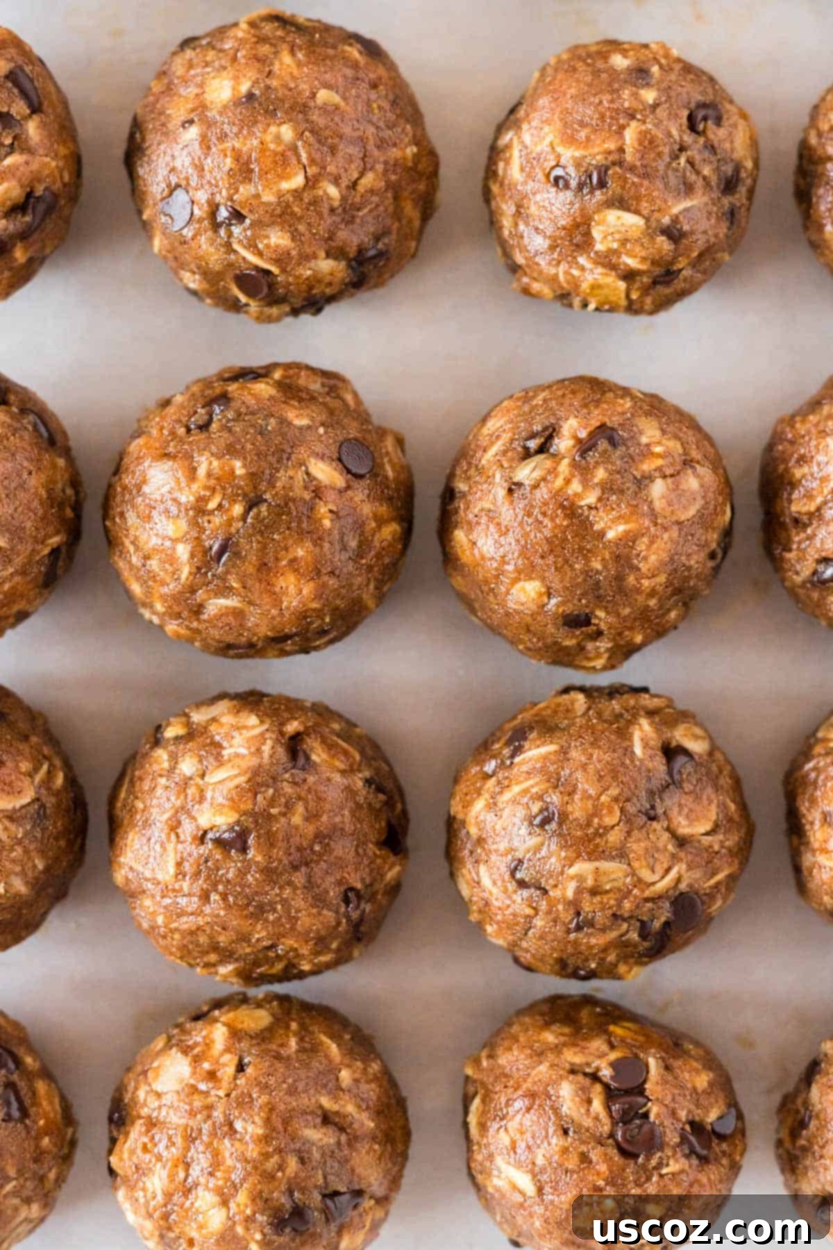 Pumpkin Protein Bites 10 More pumpkin protein balls arranged on a baking sheet after chilling