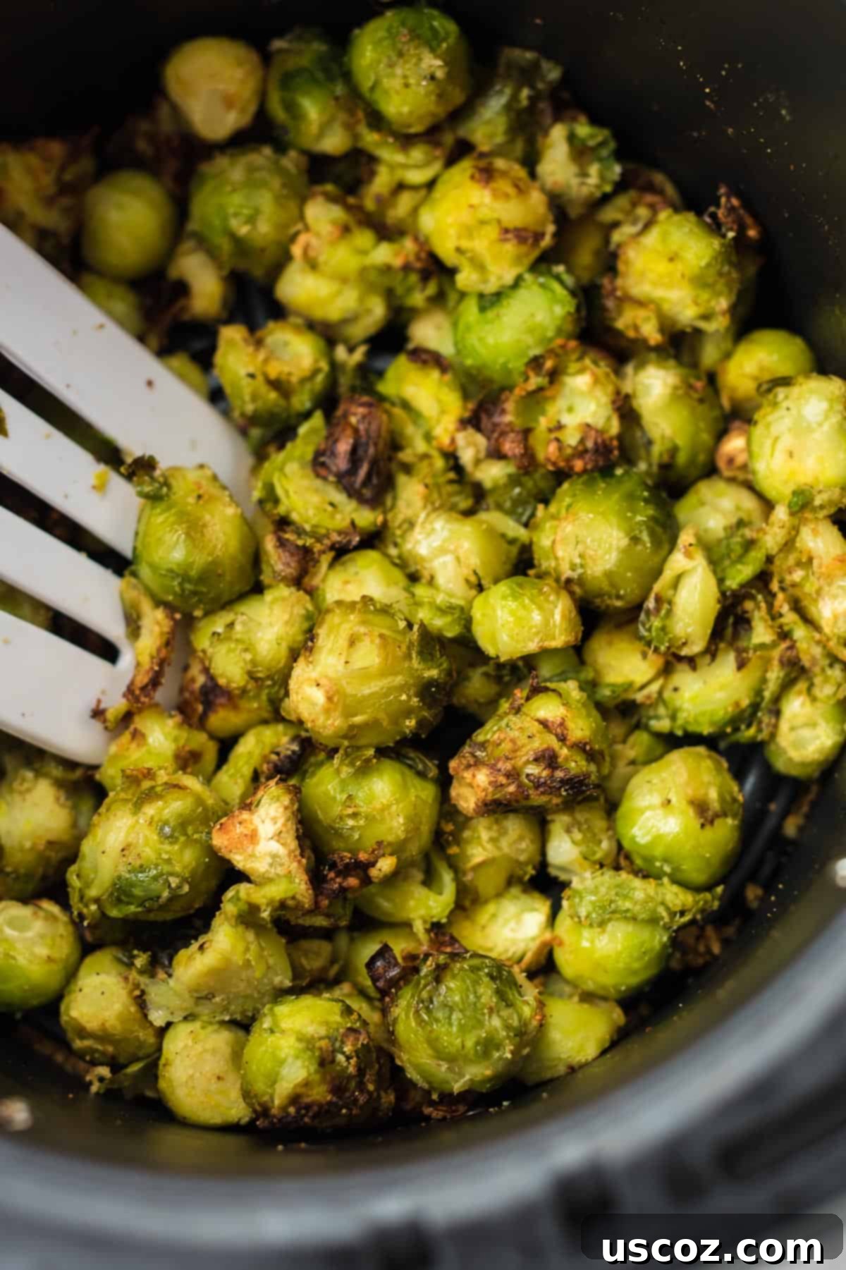 Freezer to Fork Air Fried Brussels Sprouts 6 spatula taking a scoop of brussel sprouts from the air fryer