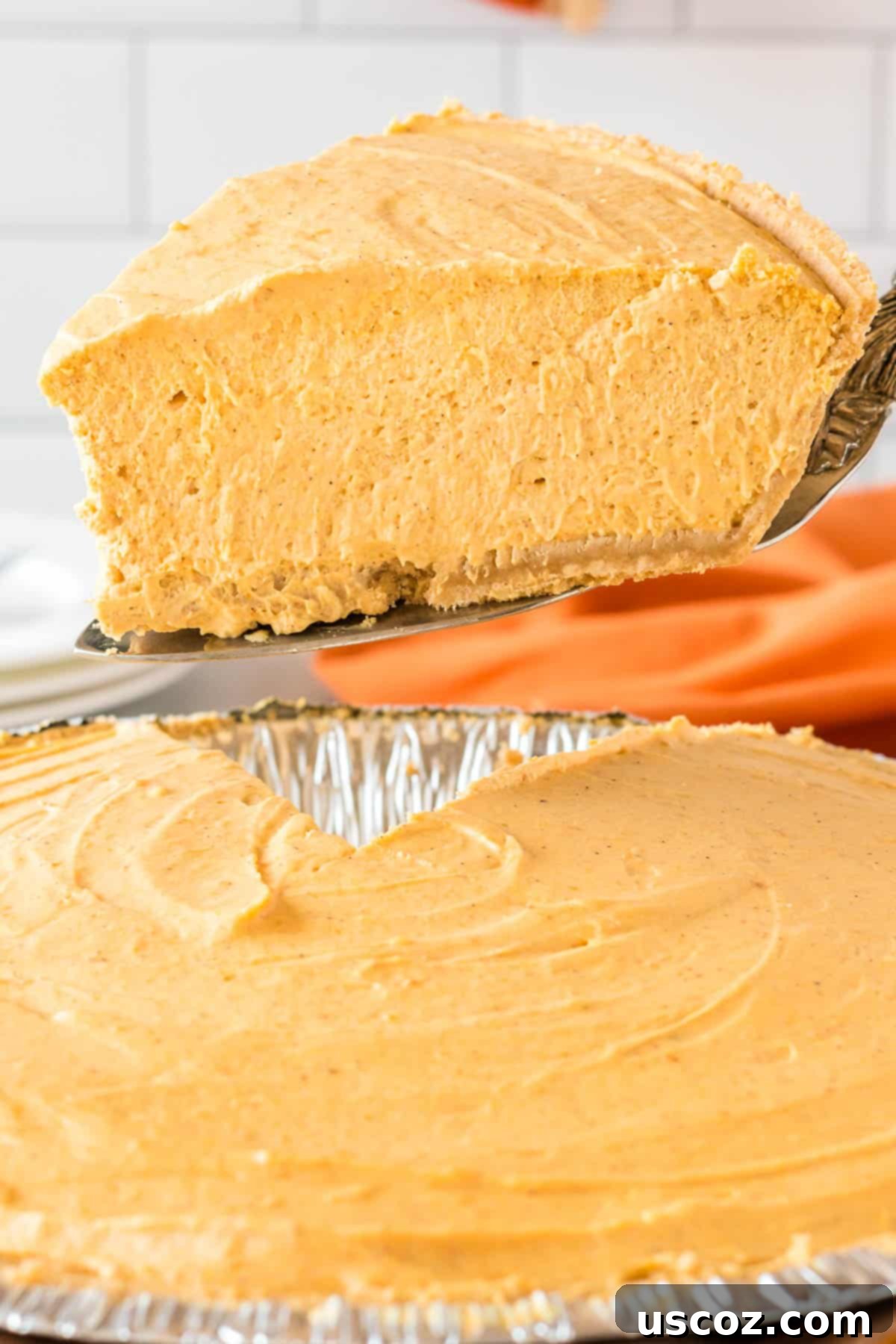 Creamy Pumpkin Delight 2 taking a slice of whipped pumpkin pie from the pie dish