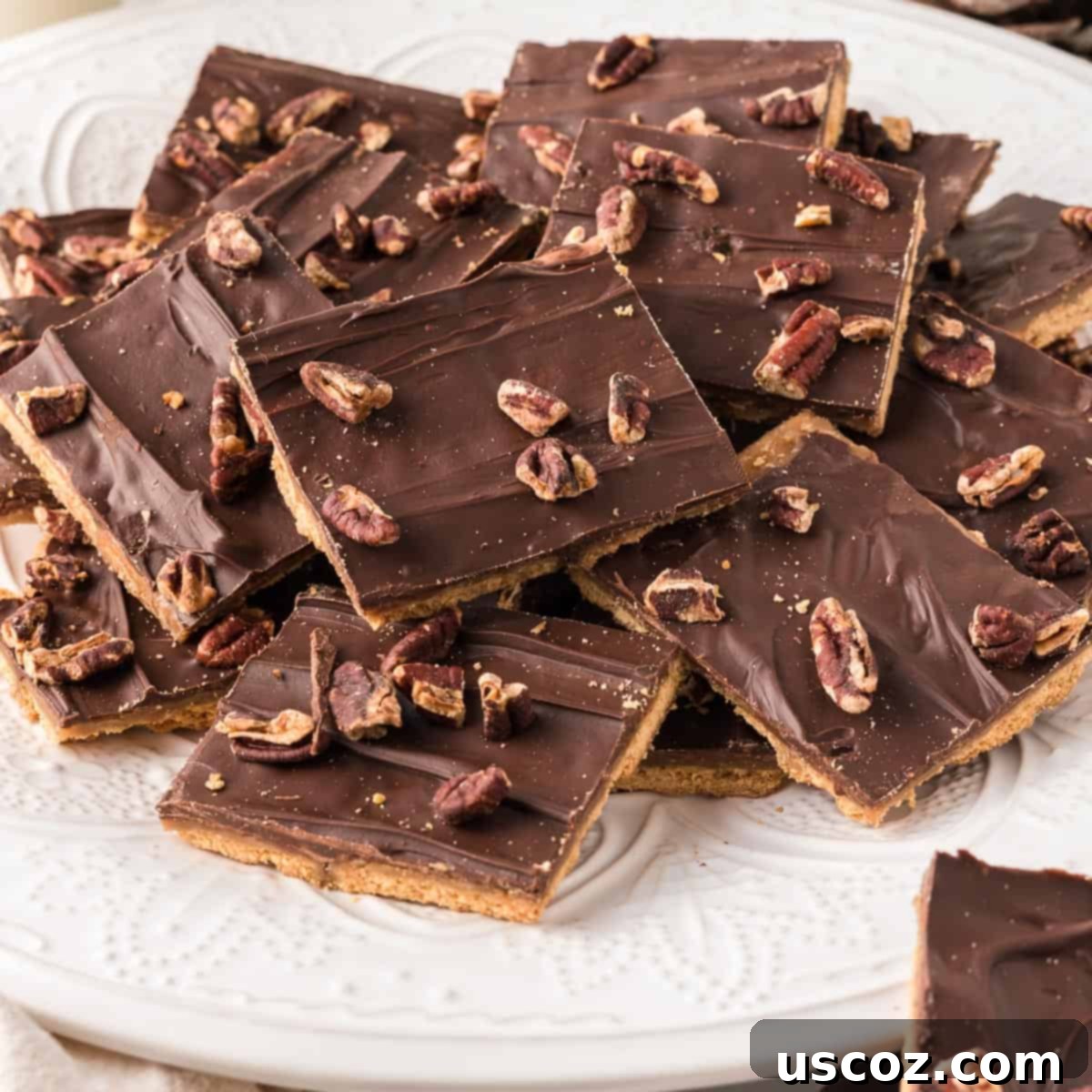 Golden Graham Toffee 3 graham cracker toffee candy on a white plate, ready to be enjoyed