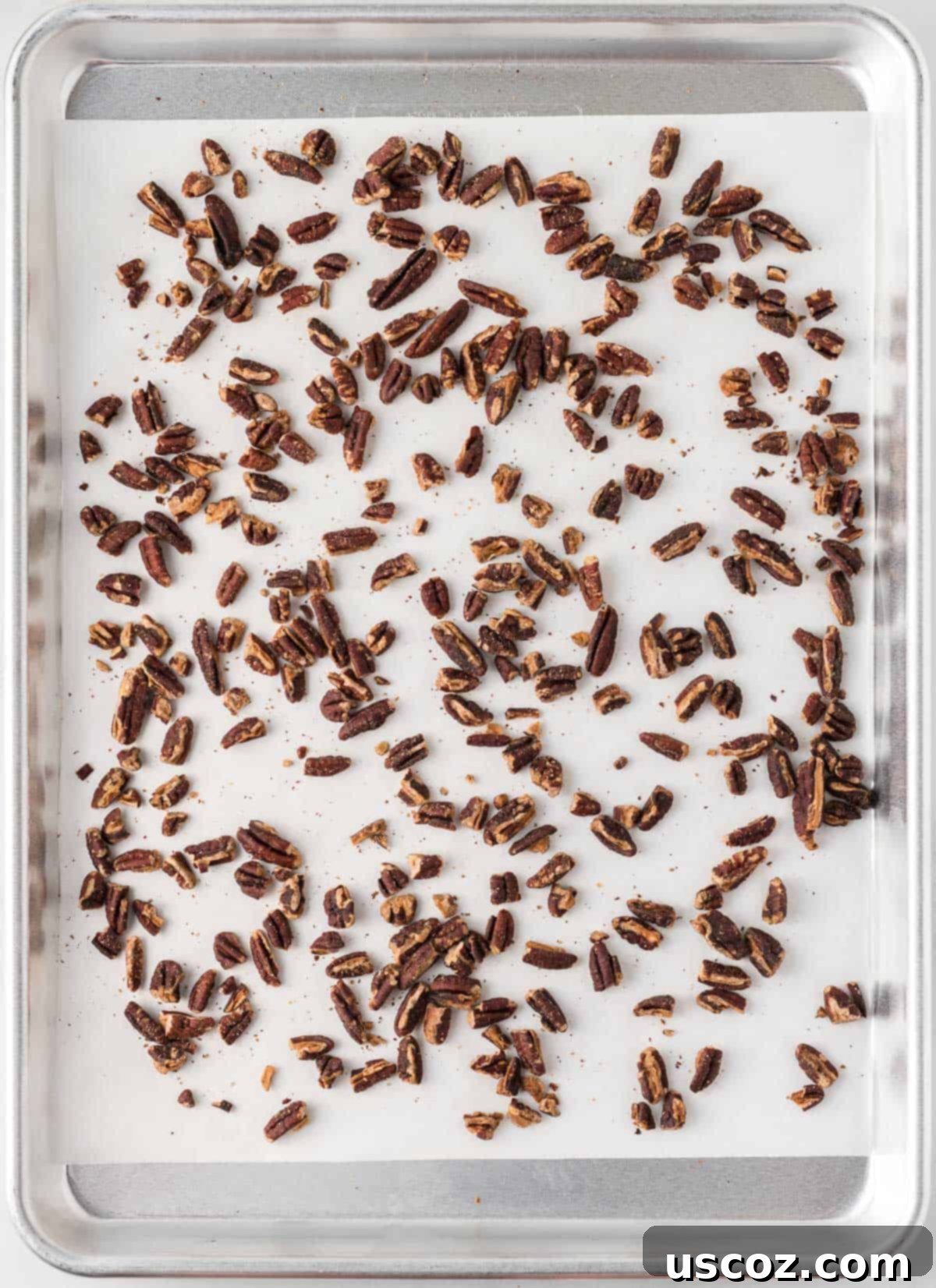Golden Graham Toffee 9 pecan pieces scattered on a baking sheet, ready for toasting