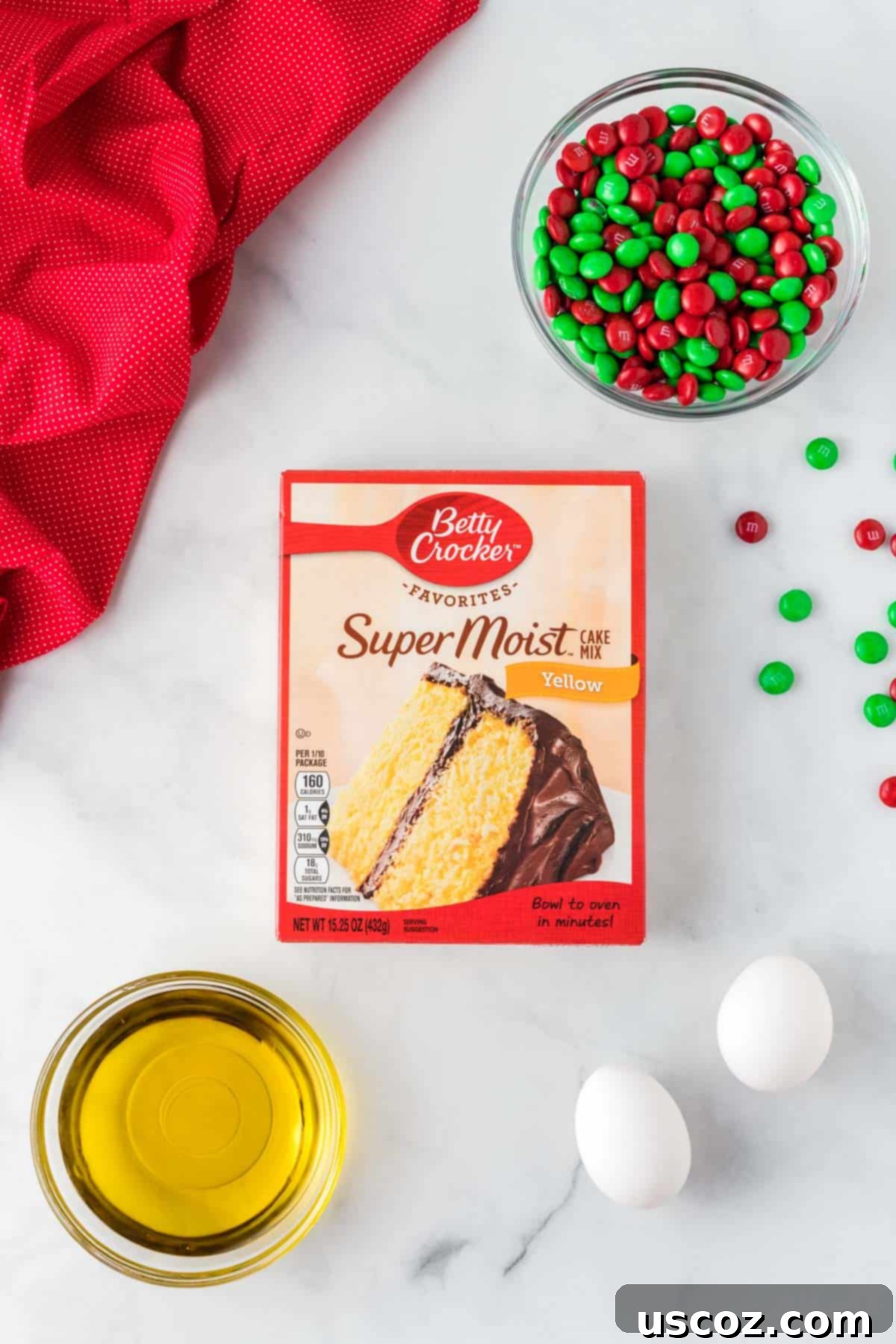 Effortless Holiday Cake Mix Cookies 4 The simple ingredients laid out: yellow cake mix, eggs, oil, and red and green Christmas M&M's
