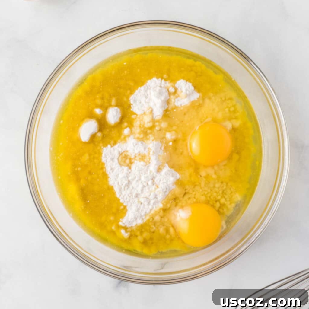 Effortless Holiday Cake Mix Cookies 5 Yellow cake mix, oil, and eggs in a mixing bowl before combining
