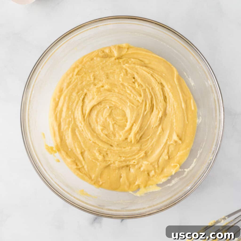 Effortless Holiday Cake Mix Cookies 6 Smooth, well-mixed cake mix cookie batter in a bowl, ready for M&M's